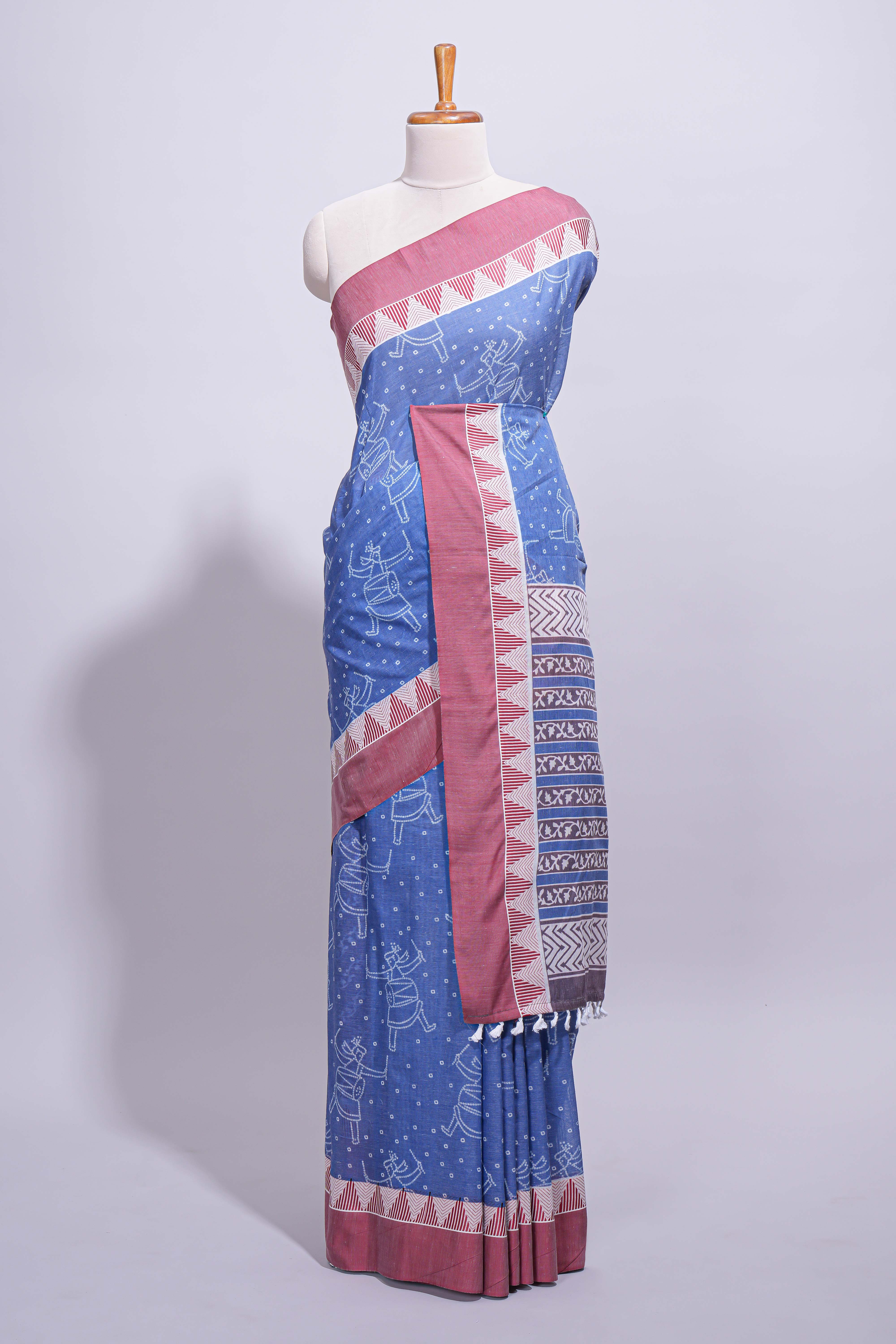 Blue linen small dotted elephant and floral motifs contrast border and printed pallu with geometric patterns and tassel detailing along with printed blouse