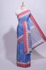 Blue linen small dotted elephant and floral motifs contrast border and printed pallu with geometric patterns and tassel detailing along with printed blouse