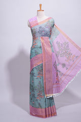 Turquoise linen saree withbodyfloral and traditional motifs with a contrastingpallu striped zari border and tassel along with contrast blouse