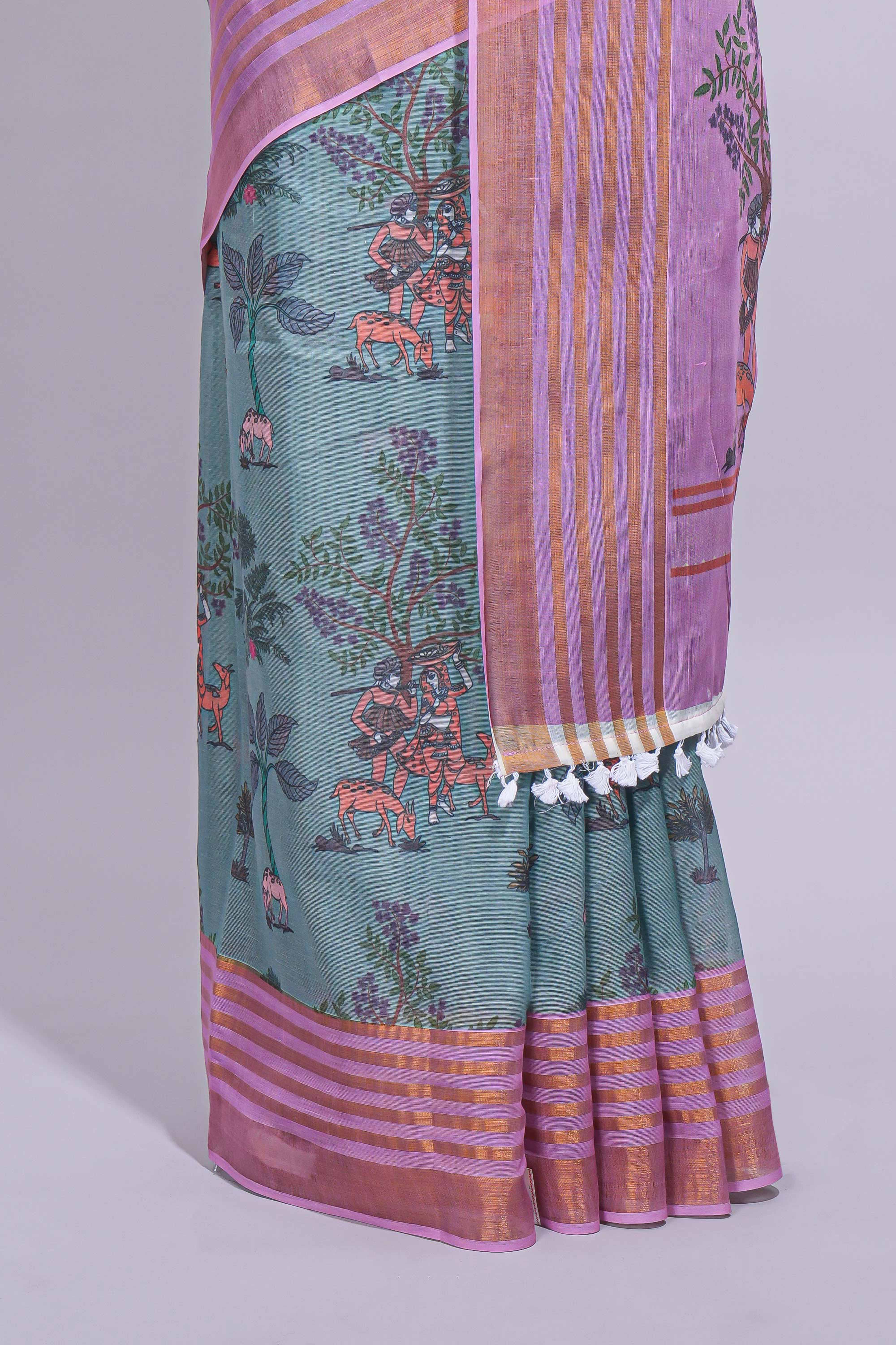 Turquoise linen saree withbodyfloral and traditional motifs with a contrastingpallu striped zari border and tassel along with contrast blouse