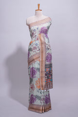 Ivory colour linen saree floral prints with pastel accents by a subtle gold zari border and printed pallu with tassel along with printed blouse