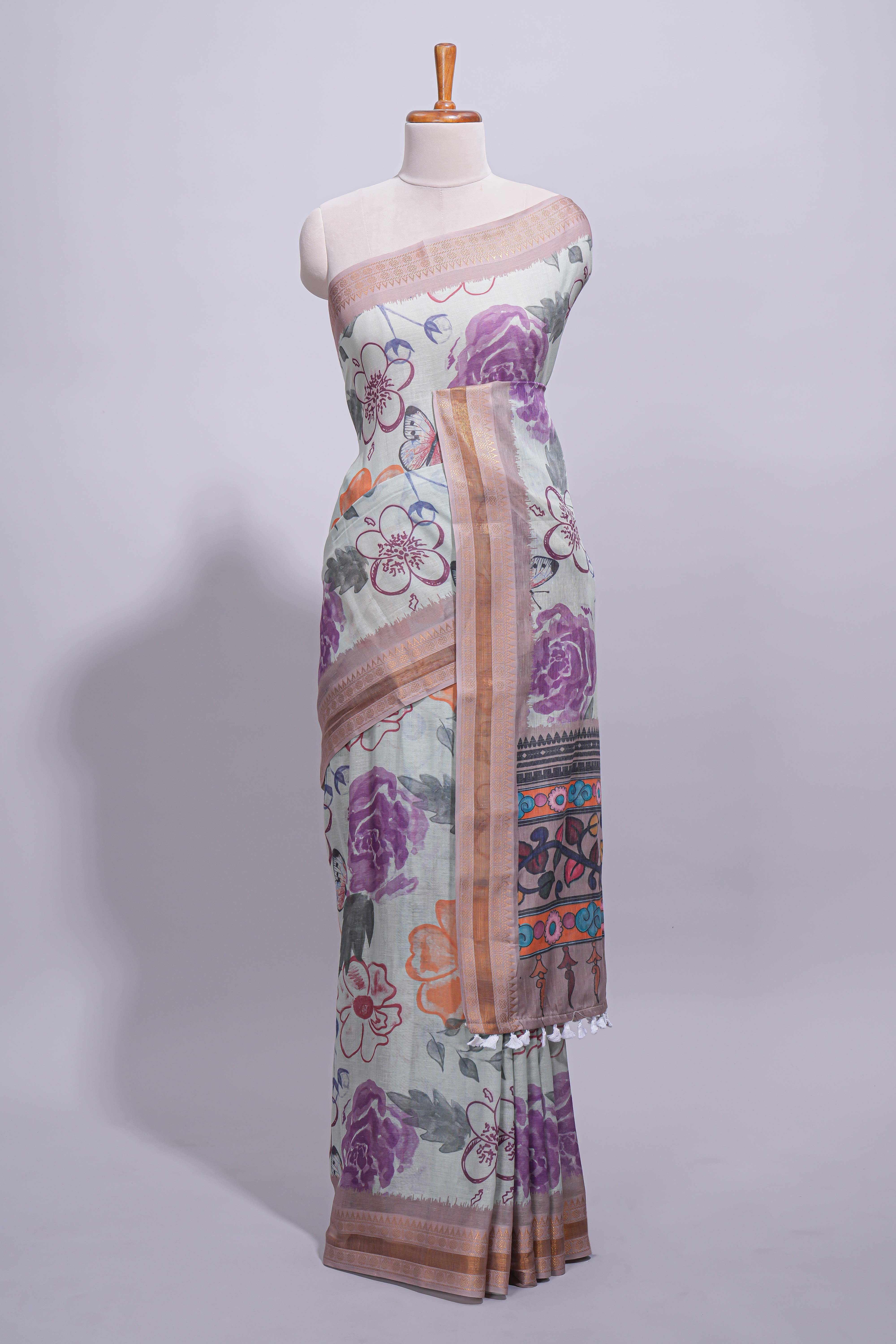 Ivory colour linen saree floral prints with pastel accents by a subtle gold zari border and printed pallu with tassel along with printed blouse