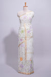 White linen saree delicate floral prints with pastel accents by a subtle gold zari border andstriped pallu with tasselalong with self blouse