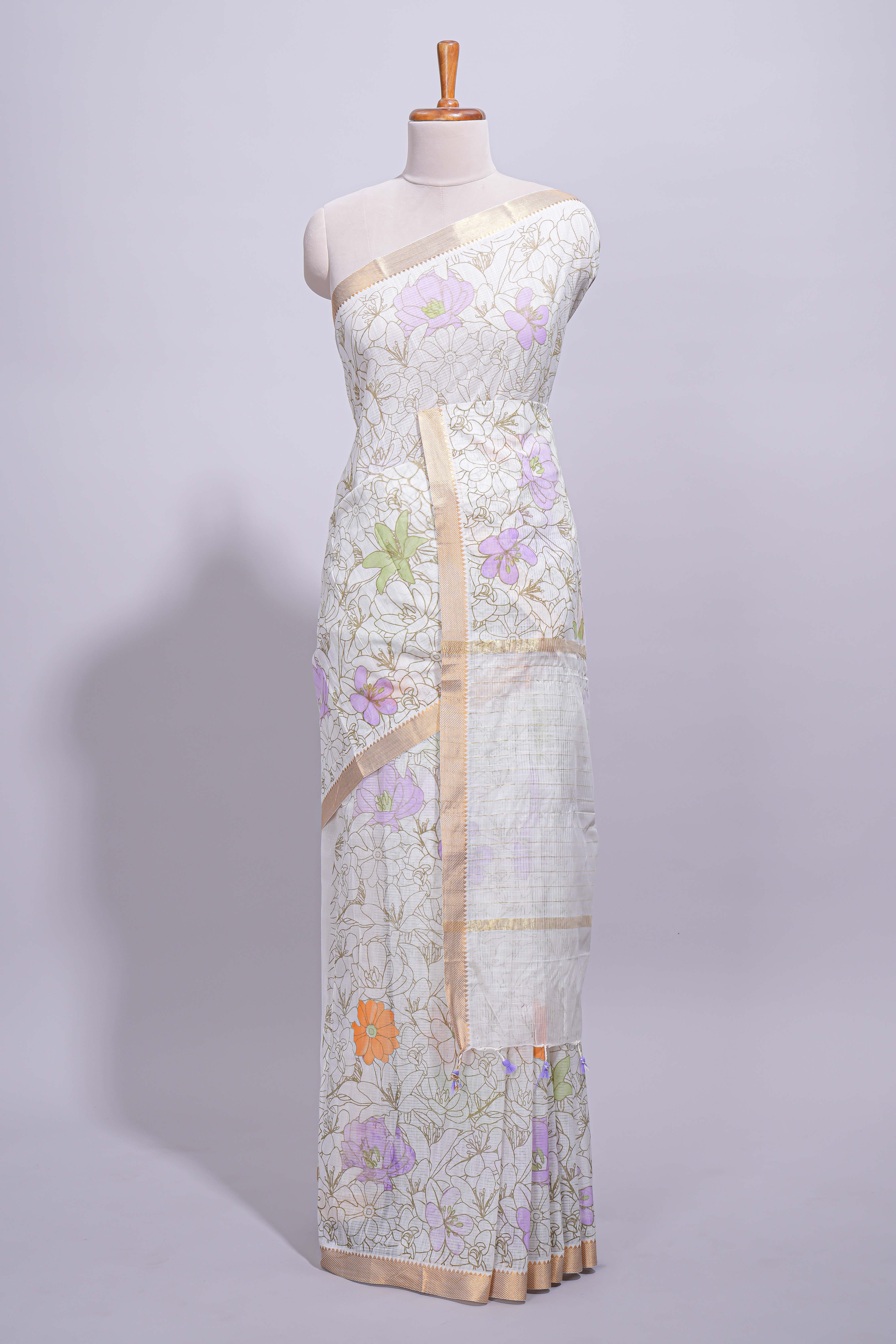 White linen saree delicate floral prints with pastel accents by a subtle gold zari border andstriped pallu with tasselalong with self blouse