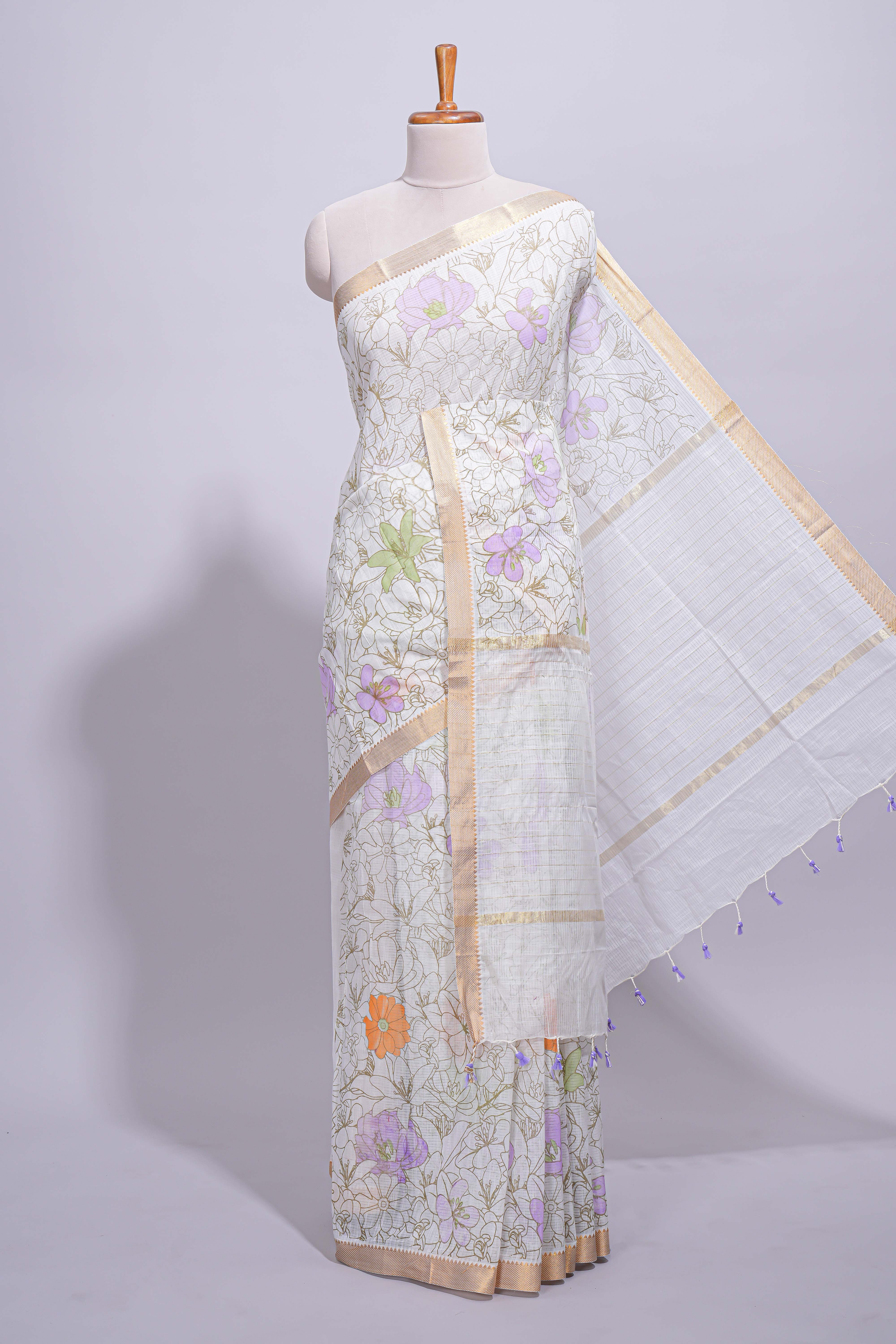 White linen saree delicate floral prints with pastel accents by a subtle gold zari border andstriped pallu with tasselalong with self blouse