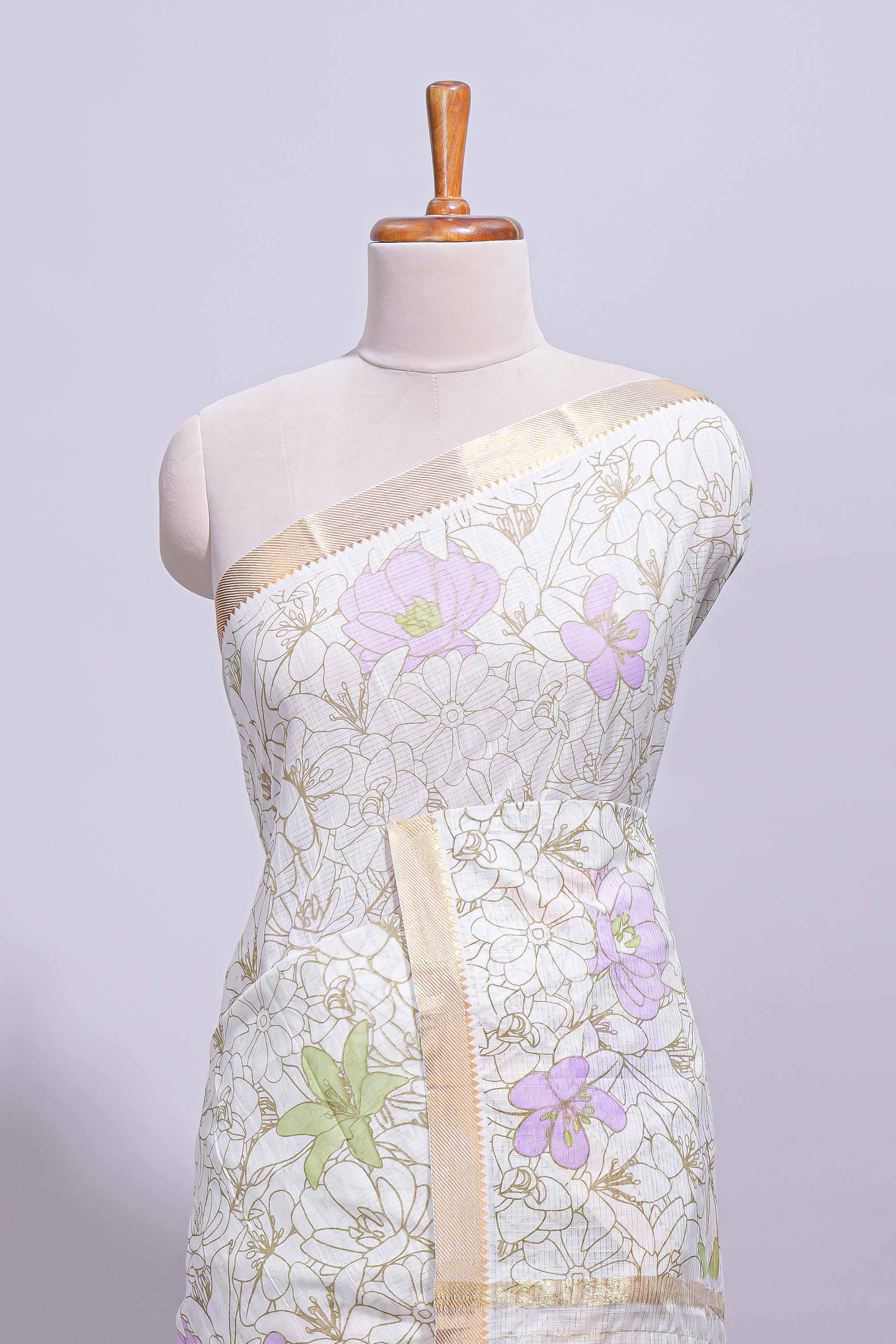 White linen saree delicate floral prints with pastel accents by a subtle gold zari border andstriped pallu with tasselalong with self blouse
