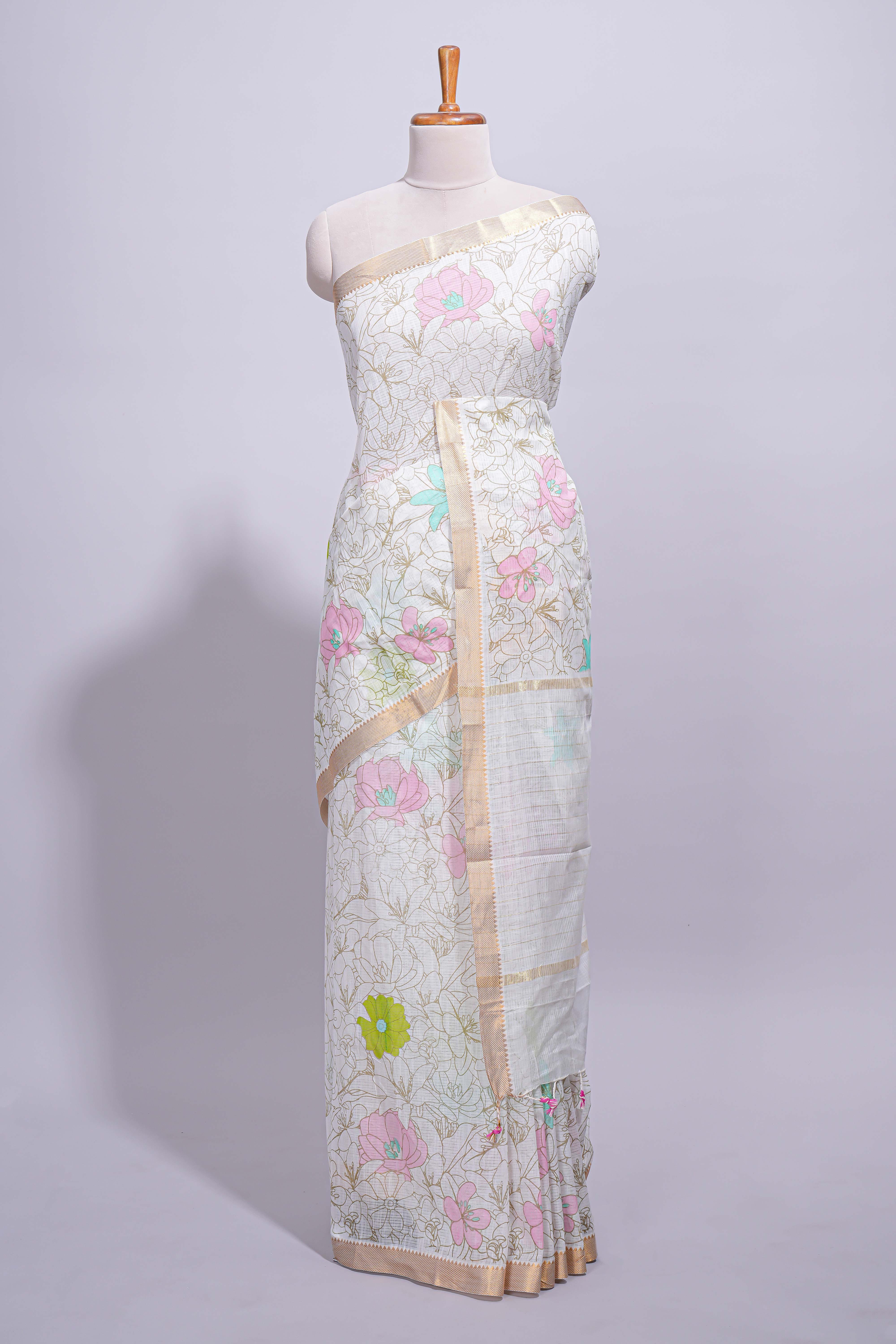 White linen saree floral prints with pastel accents by a subtle gold zari border andstriped pallu with tasselalong with self blouse