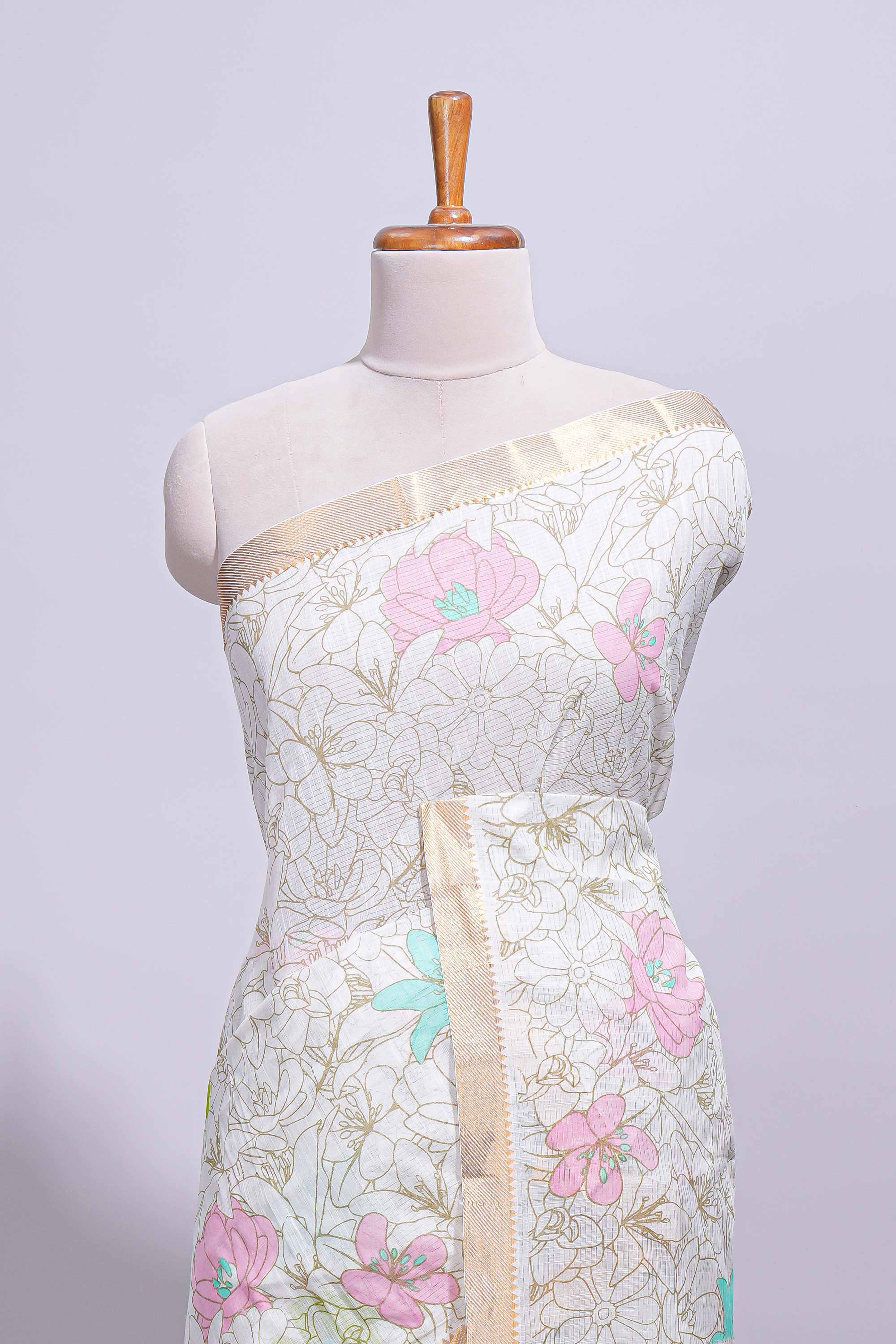 White linen saree floral prints with pastel accents by a subtle gold zari border andstriped pallu with tasselalong with self blouse