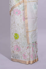 White linen saree floral prints with pastel accents by a subtle gold zari border andstriped pallu with tasselalong with self blouse