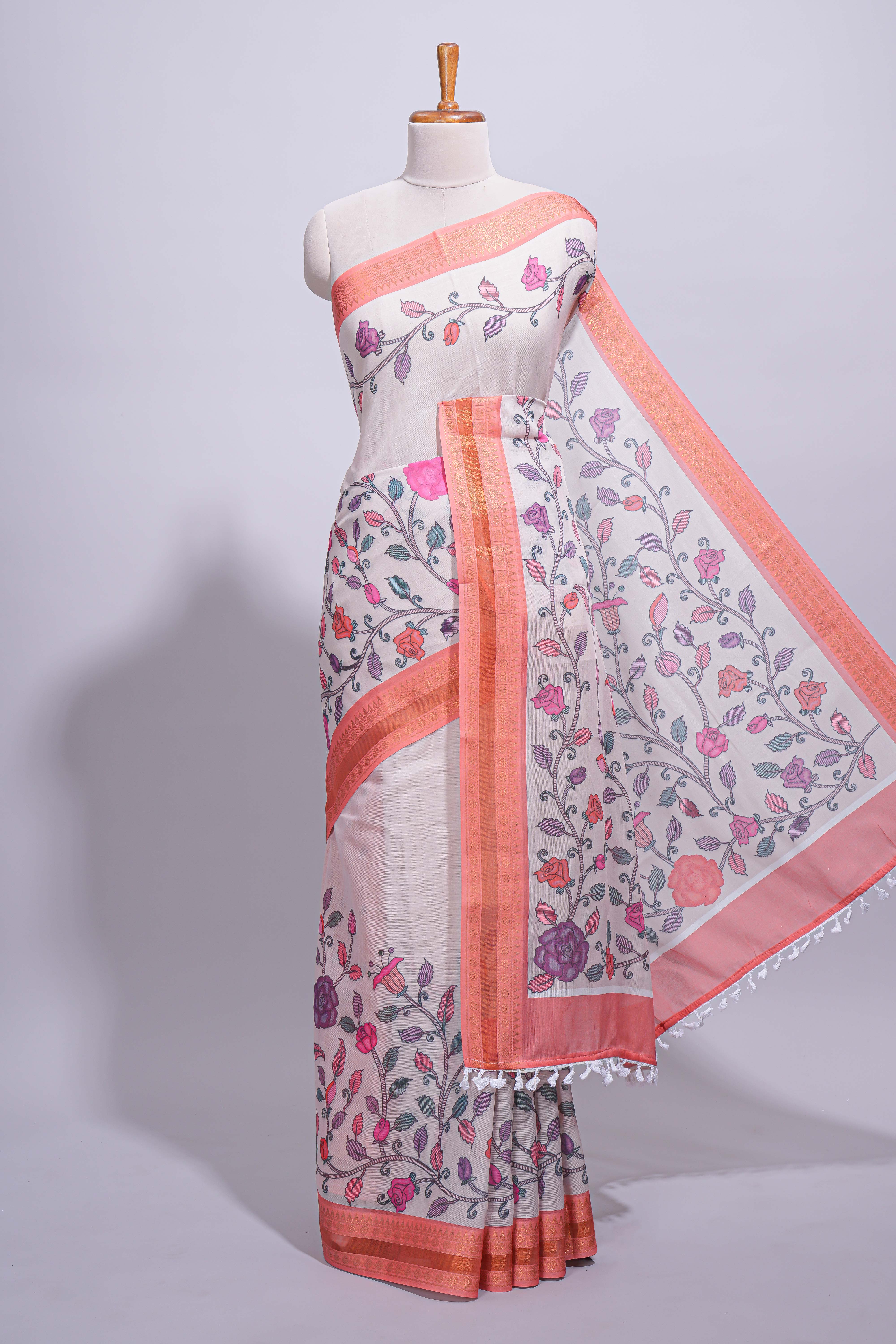 Ivory with orange linen cotton saree with multicolourfloral vine print with a contrast border and printed pallu along with printed blouse