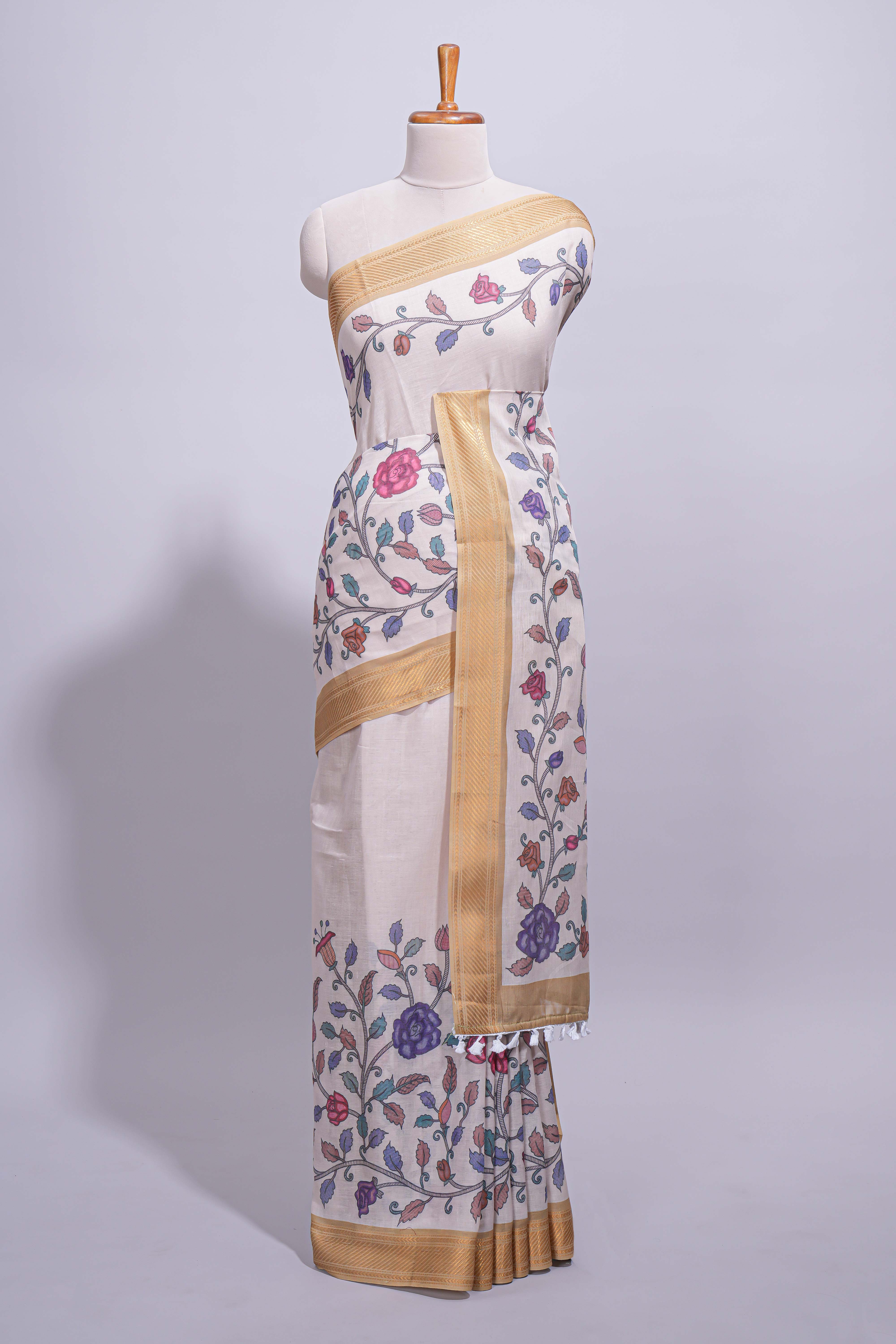 Ivory with yellow linen cotton saree with multicolourfloral vine print with a contrast border and printed pallu along with printed blouse