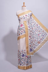 Ivory with yellow linen cotton saree with multicolourfloral vine print with a contrast border and printed pallu along with printed blouse