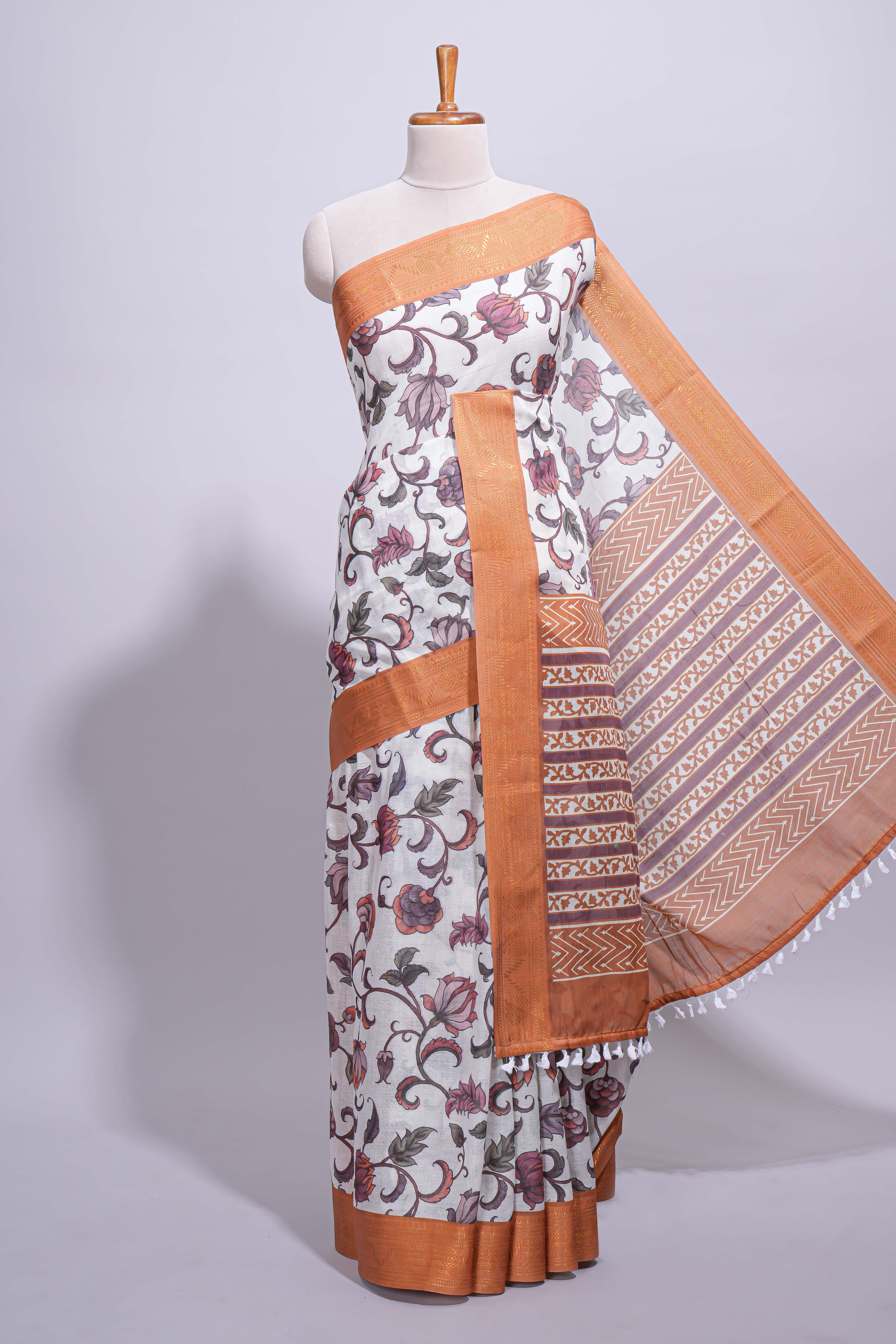 White with orange linen cotton saree with multicolourfloral vine print with a contrast border and printed pallu along with printed blouse