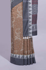 Brown linen small dotted elephant and floral motifs contrast border and printed pallu with geometric patterns and tassel detailing along with printed blouse