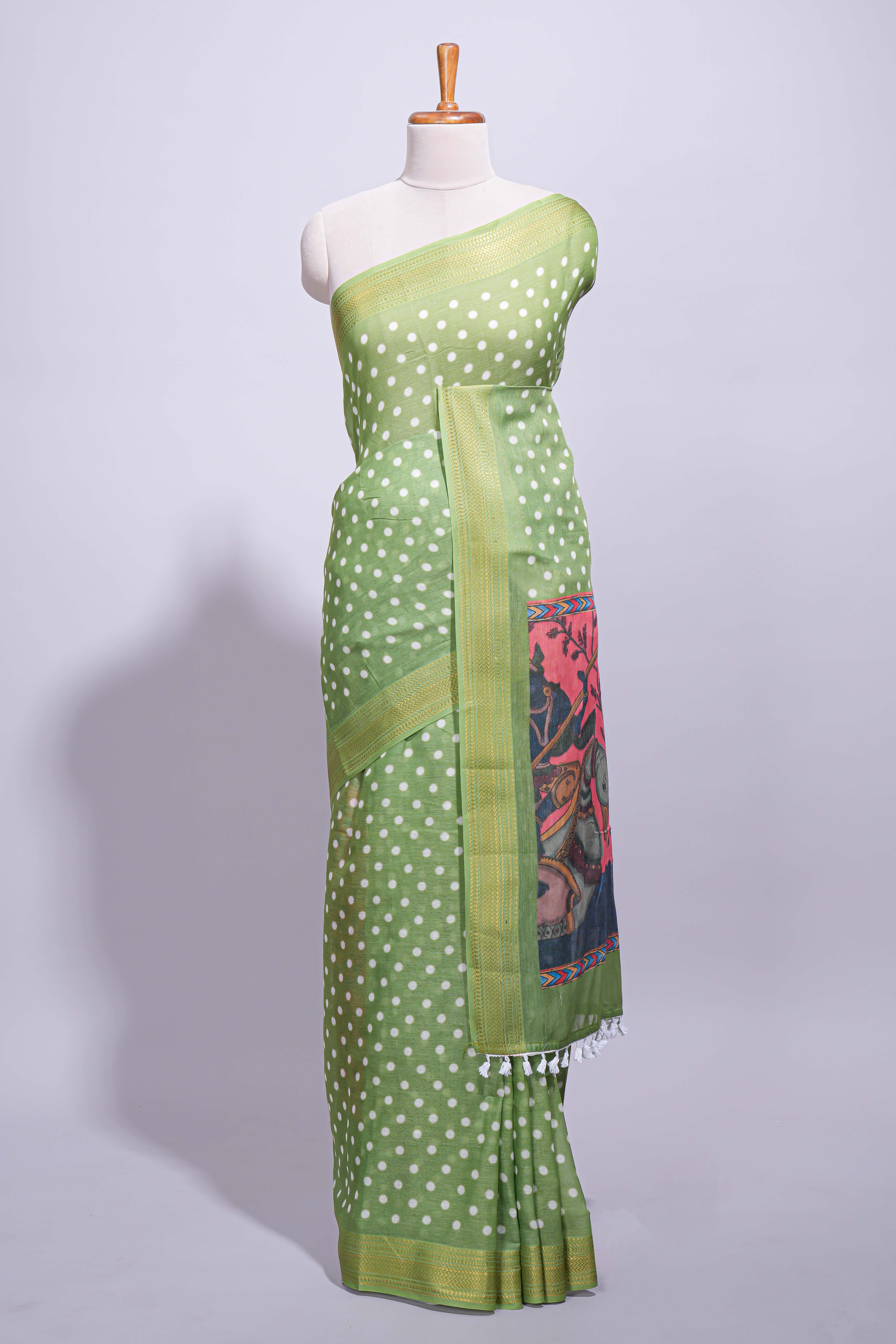 Green linen saree white polka dot pattern all over the body and self zari border with printed pallu along with printed blouse