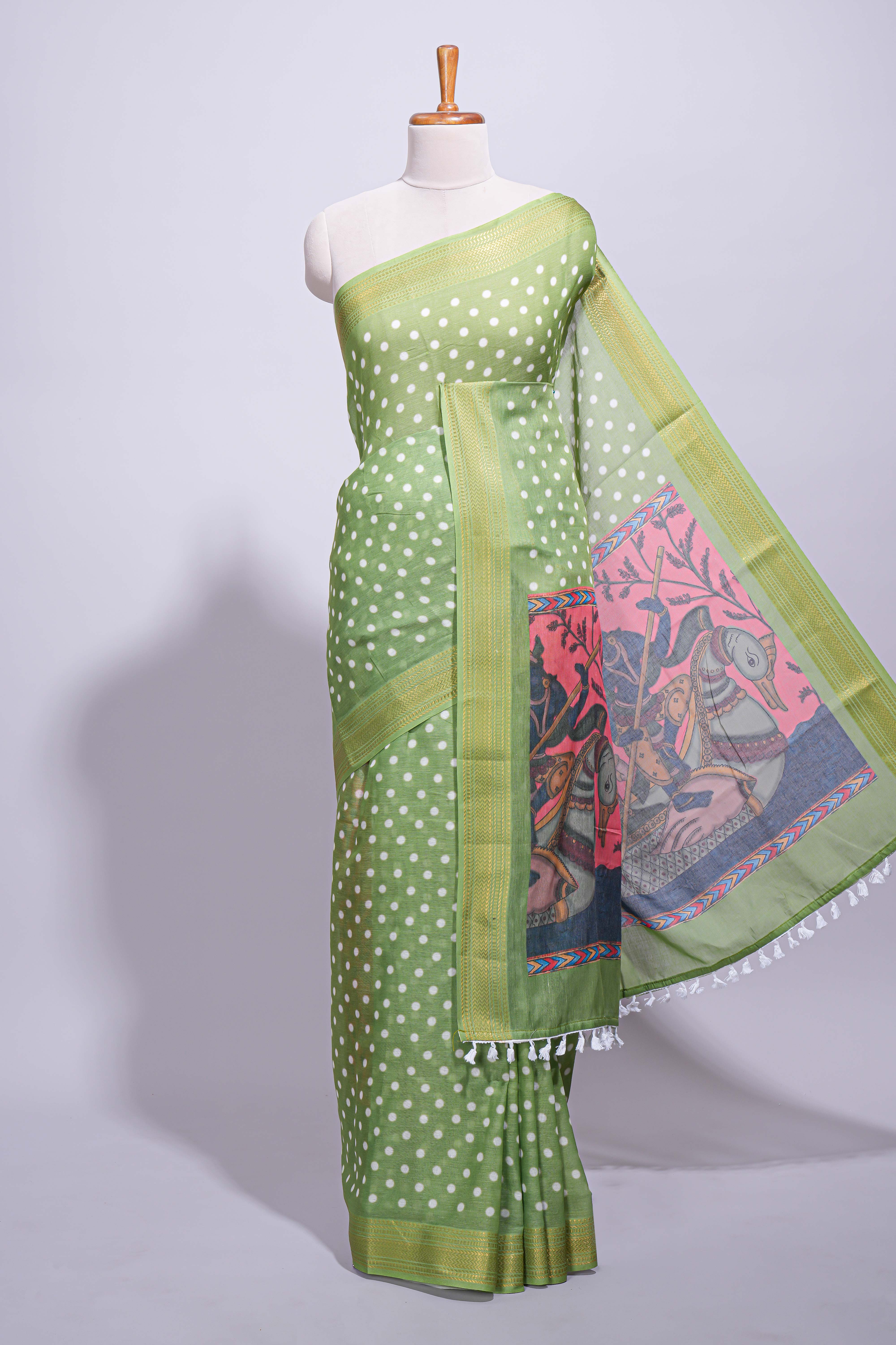 Green linen saree white polka dot pattern all over the body and self zari border with printed pallu along with printed blouse