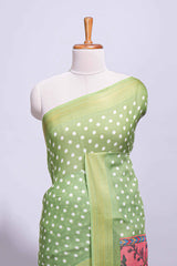 Green linen saree white polka dot pattern all over the body and self zari border with printed pallu along with printed blouse