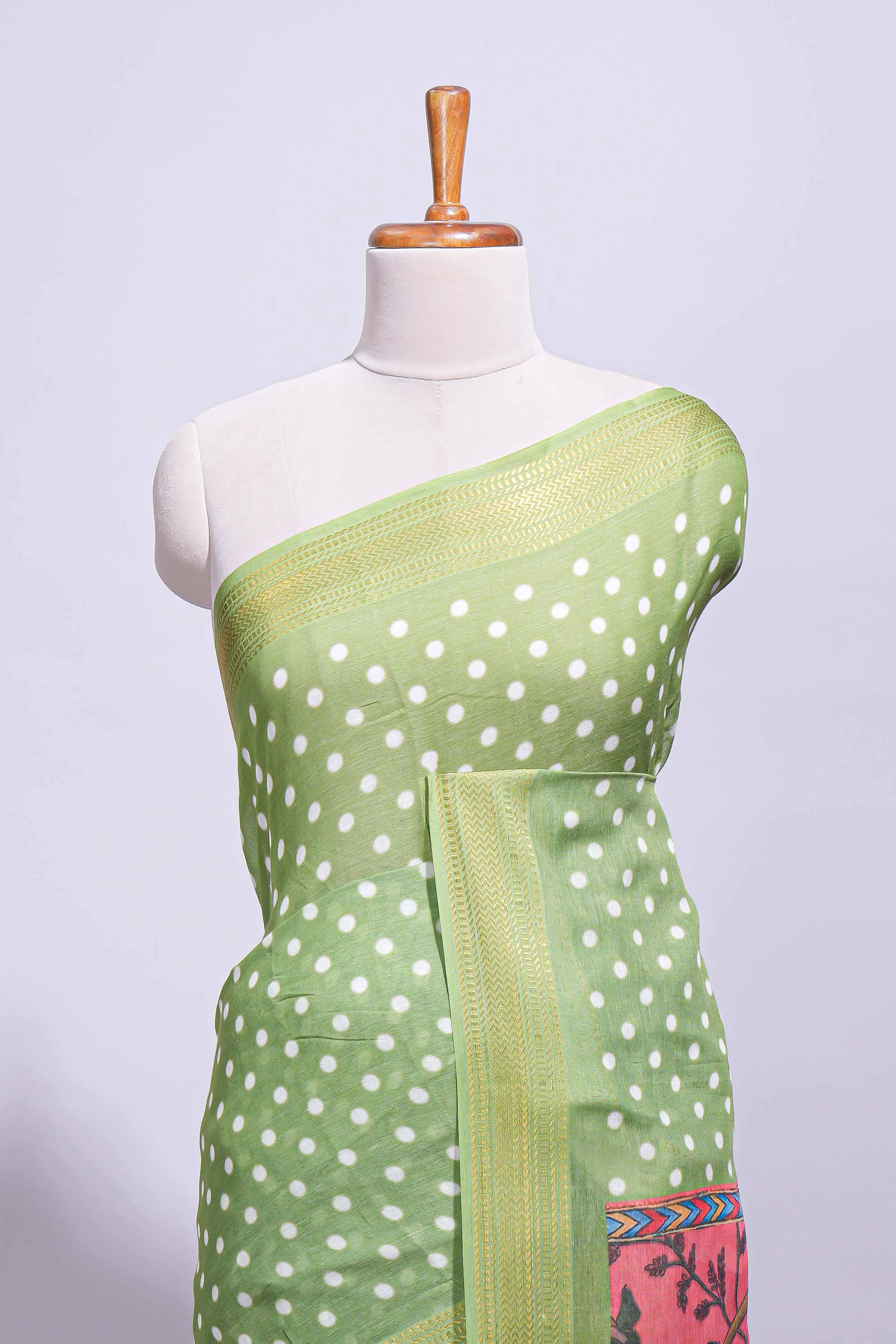 Green linen saree white polka dot pattern all over the body and self zari border with printed pallu along with printed blouse