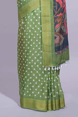 Green linen saree white polka dot pattern all over the body and self zari border with printed pallu along with printed blouse