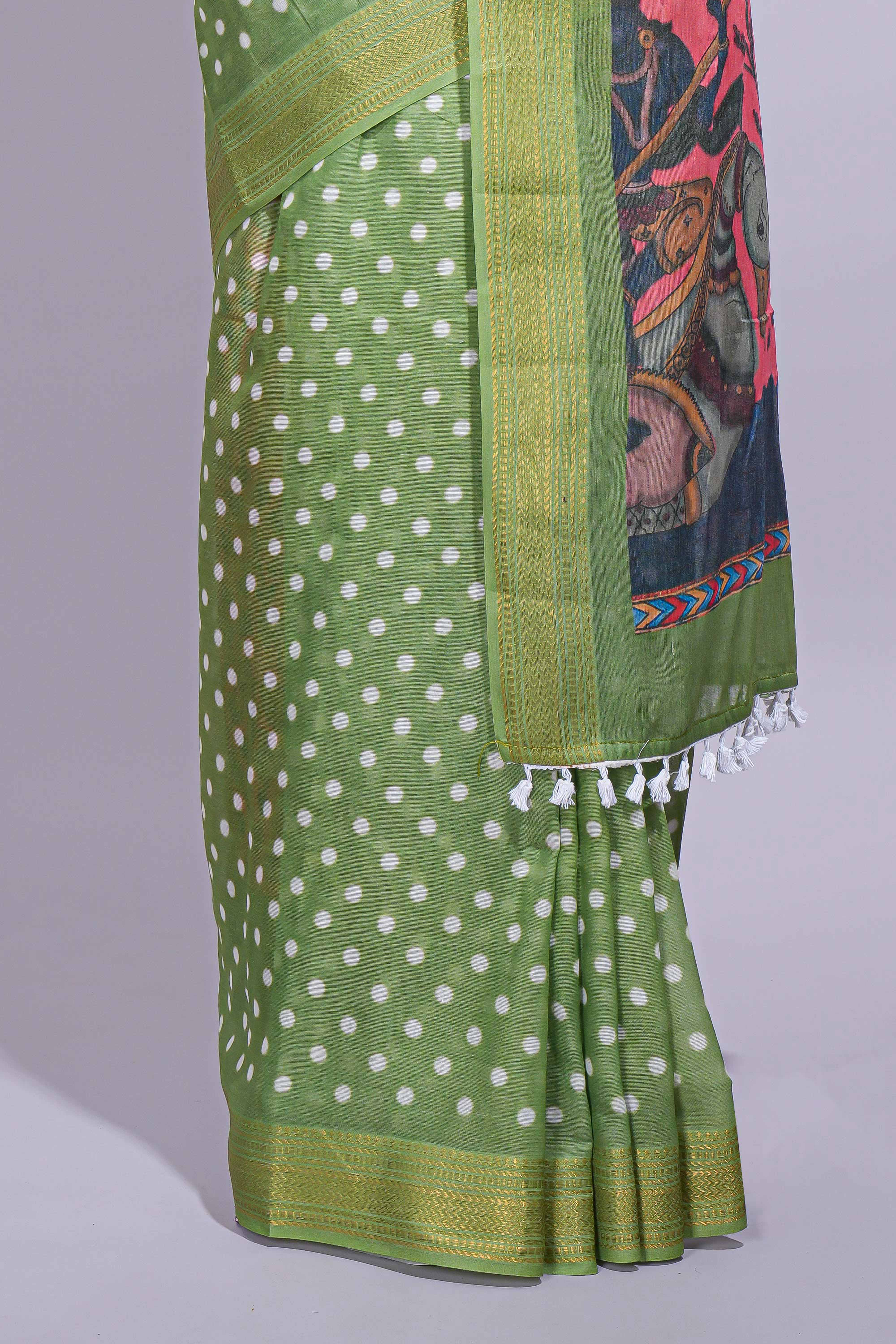 Green linen saree white polka dot pattern all over the body and self zari border with printed pallu along with printed blouse