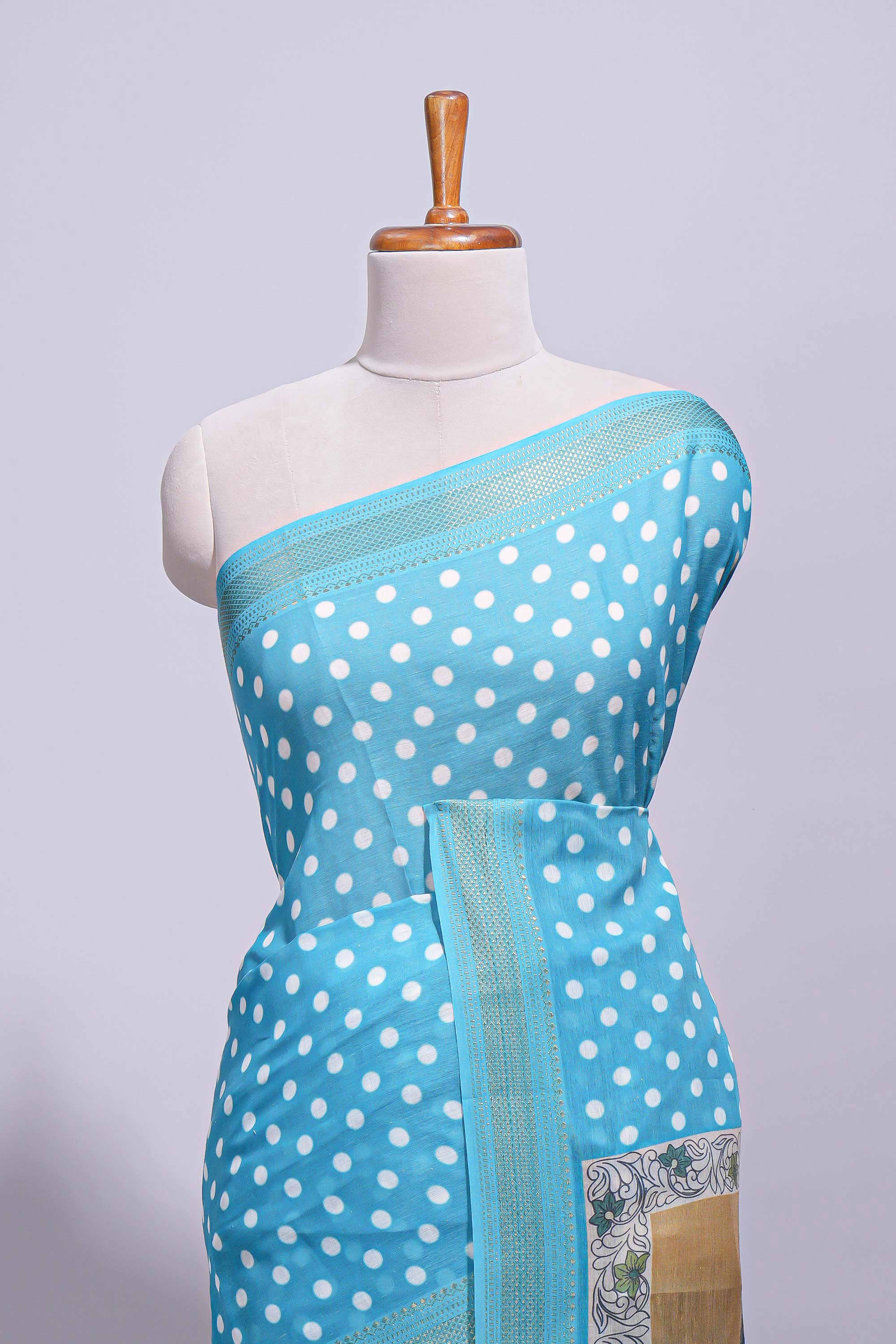 Blue linen saree white polka dot pattern all over the body and self zari border with printed pallu along with printed blouse