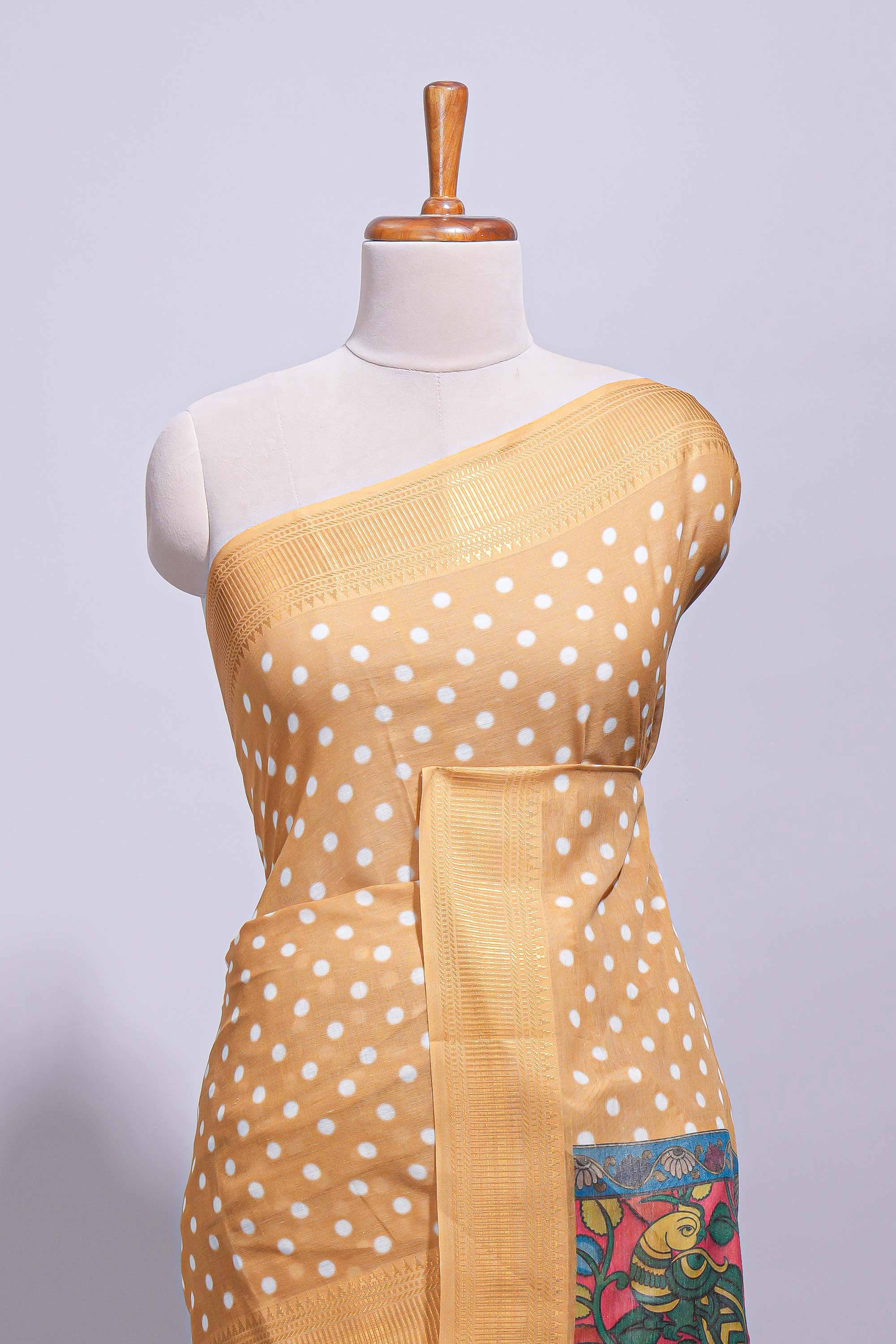 Mustard yellow linen saree white polka dot pattern all over the body and self zari border with printed pallu along with printed blouse