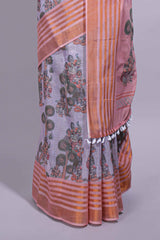 Lavender linen saree withbodyfloral and traditional motifs with a contrastingpallu striped zari border and tassel along with contrast blouse