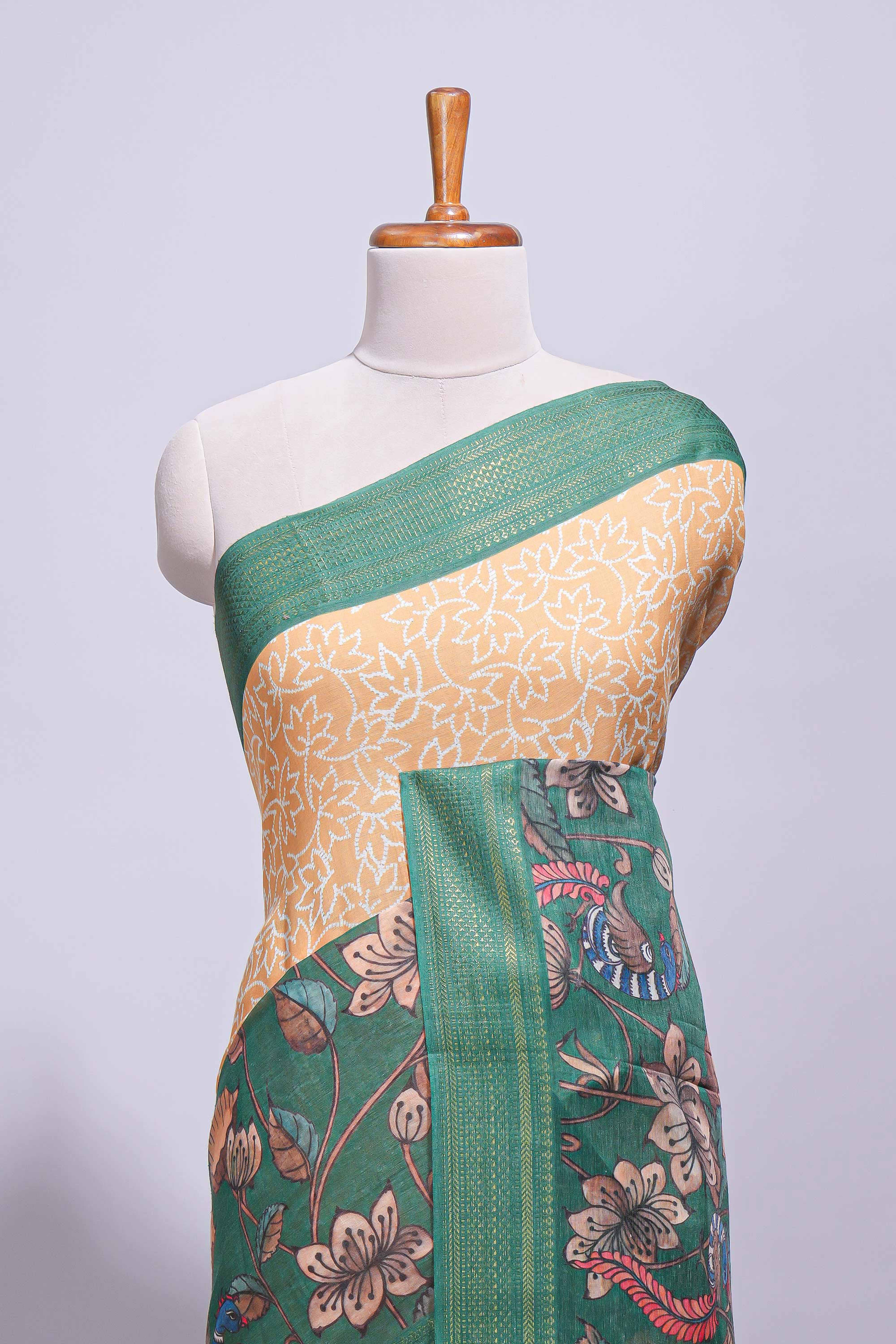 Linen saree with a mustard yellow and greenfeaturing floral patterns with a contrastfloral printed pallu and zari border with tassel