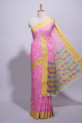 Pink linen saree with white dotted floral patterns with golden zari border and a multicolour pichwai motifs along with printed blouse