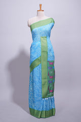 Blue linen saree with white dotted floral patterns with golden zari border and a multicolour pichwai motifs along with printed blouse