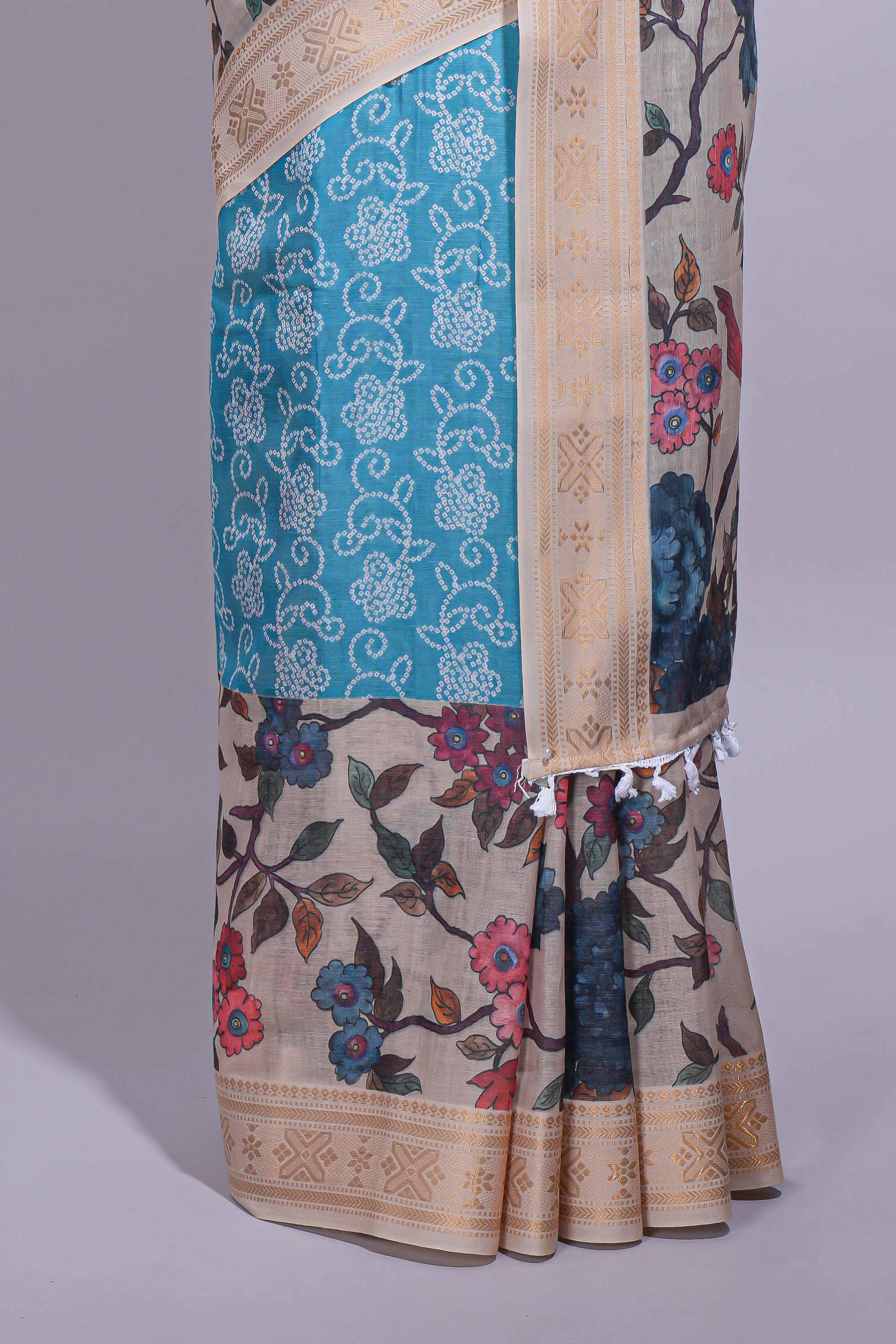 Linen saree with a blue with beige featuring floral patterns with a contrastfloral printed pallu and zari border with tassel