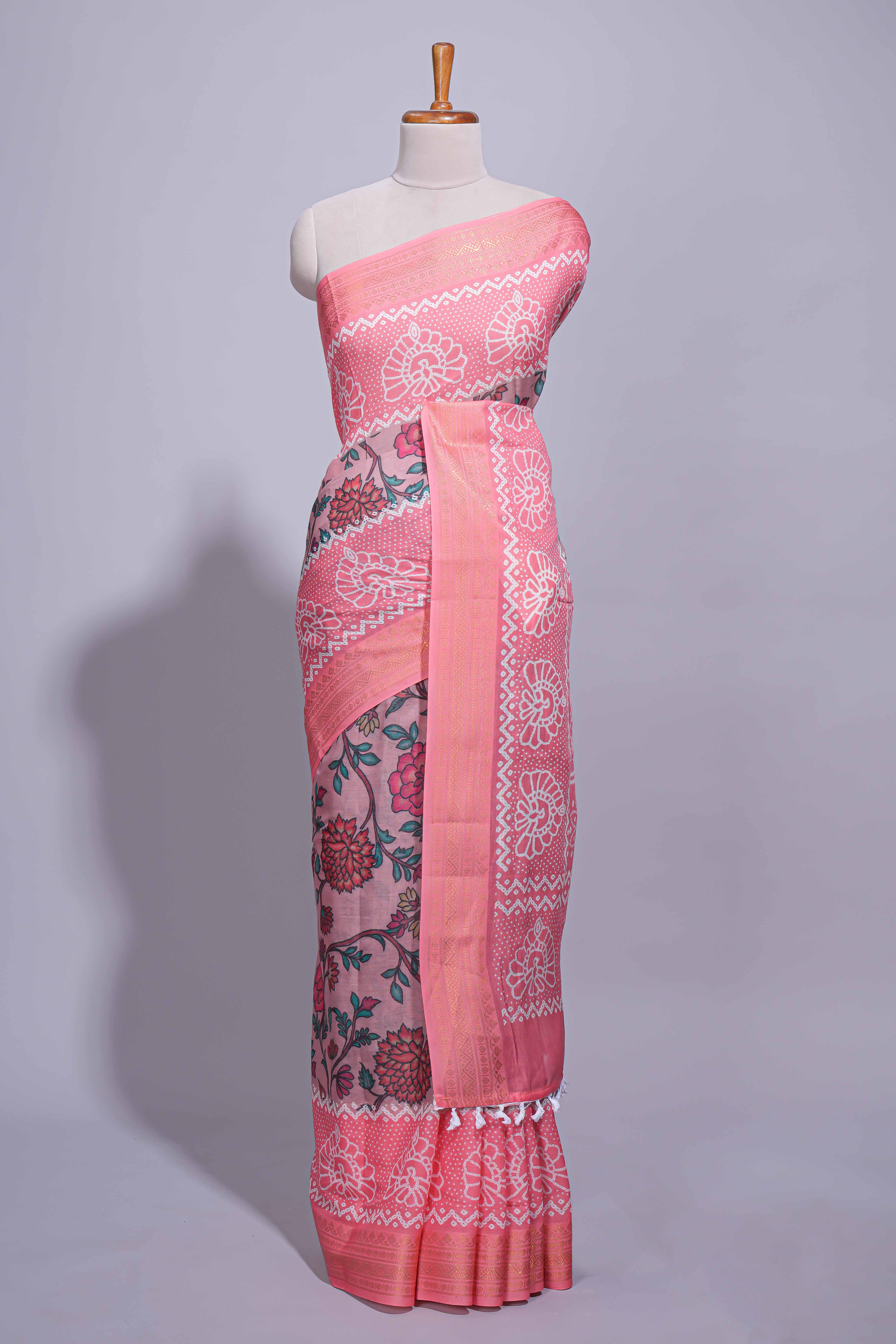 Linen saree with a pink colourfeaturing floral patterns with a contrastfloral printed pallu and zari border with tassel along with contrast blouse