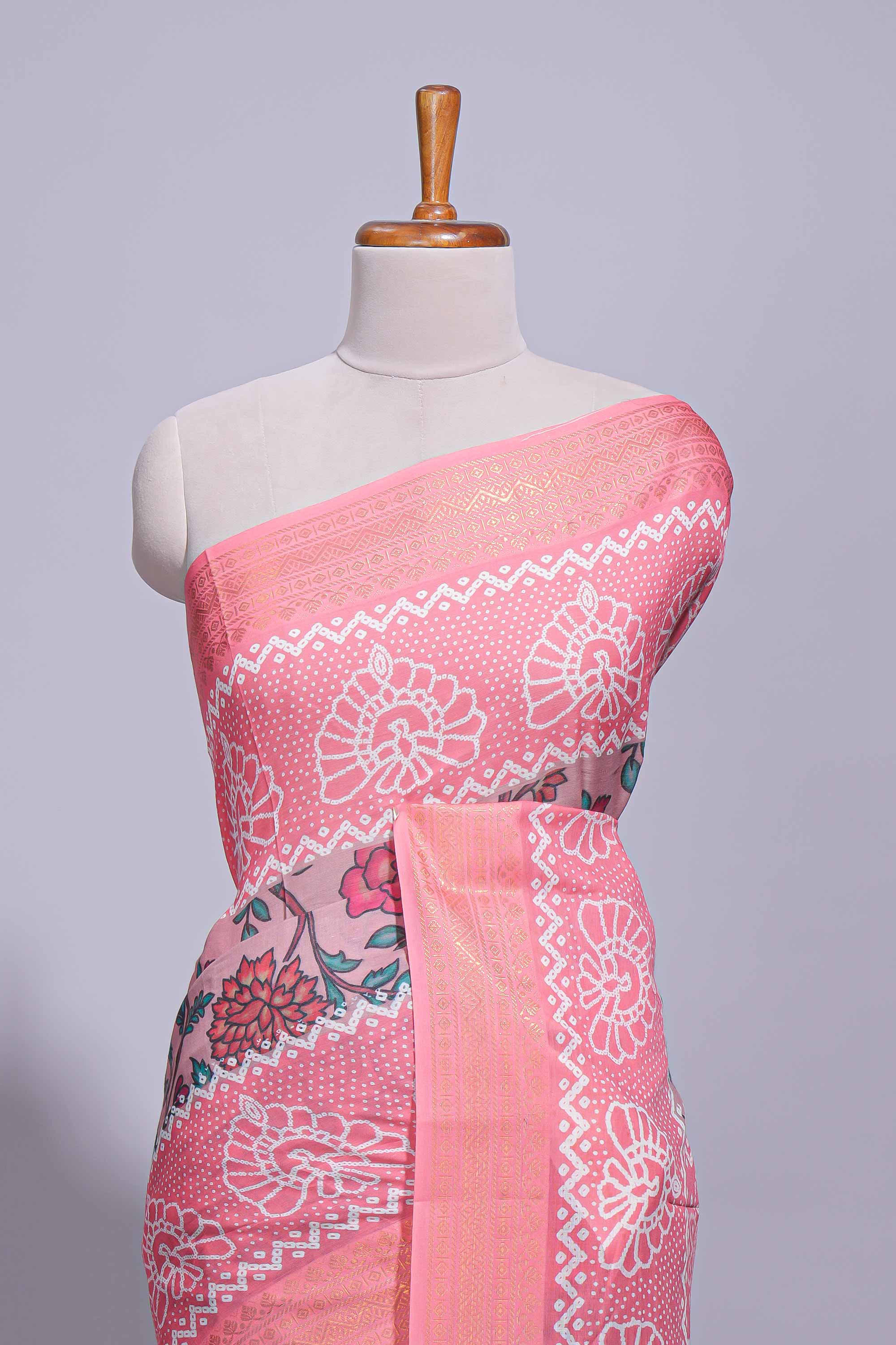 Linen saree with a pink colourfeaturing floral patterns with a contrastfloral printed pallu and zari border with tassel along with contrast blouse