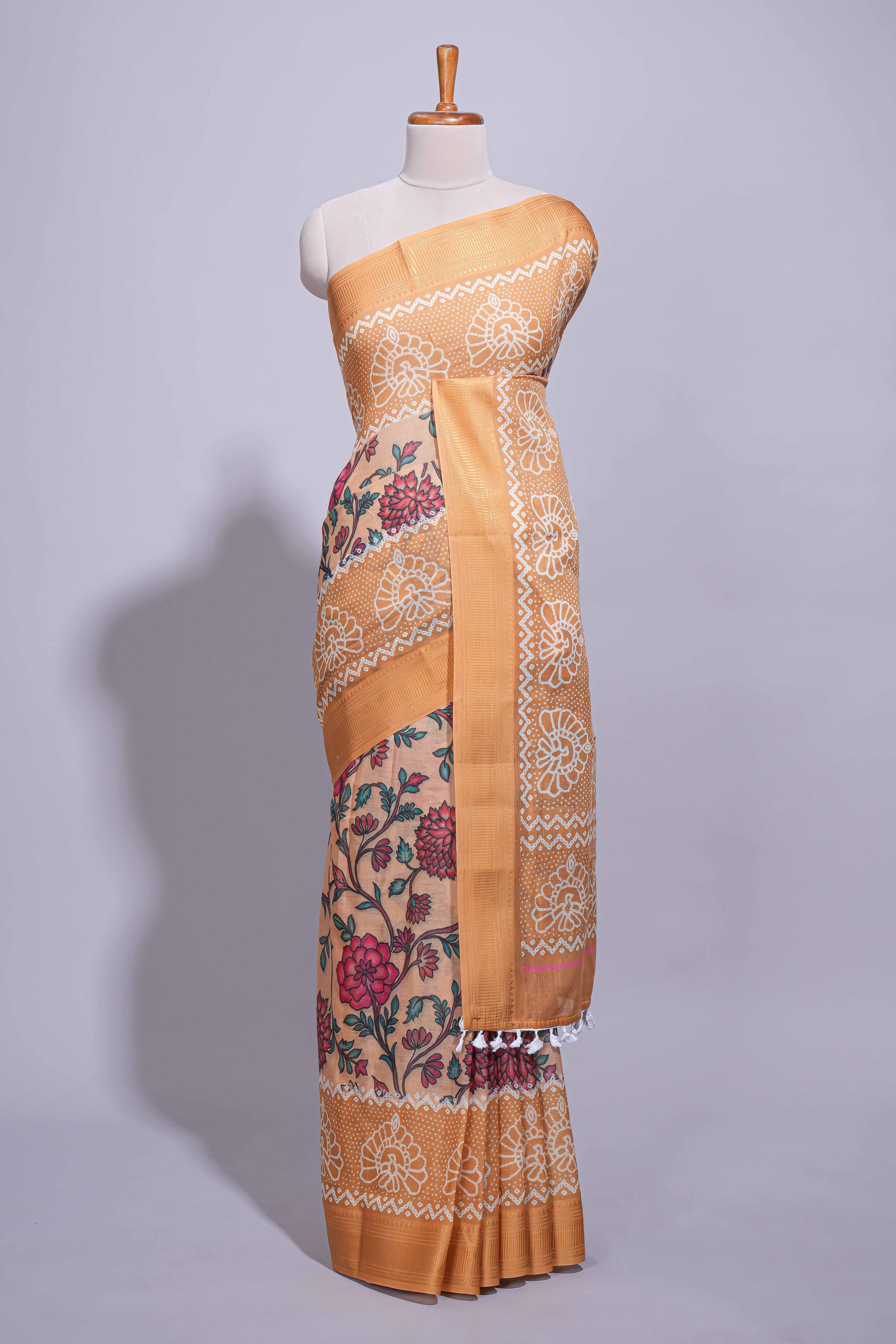 Linen saree with a orange colourfeaturing floral patterns with a contrastfloral printed pallu and zari border with tassel along with contrast blouse