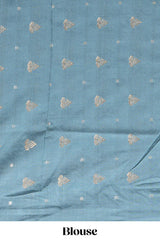 Soft pink linen saree with floral print highlighted with a contrast floral pallu and metallic zari border along with contrast blouse piece