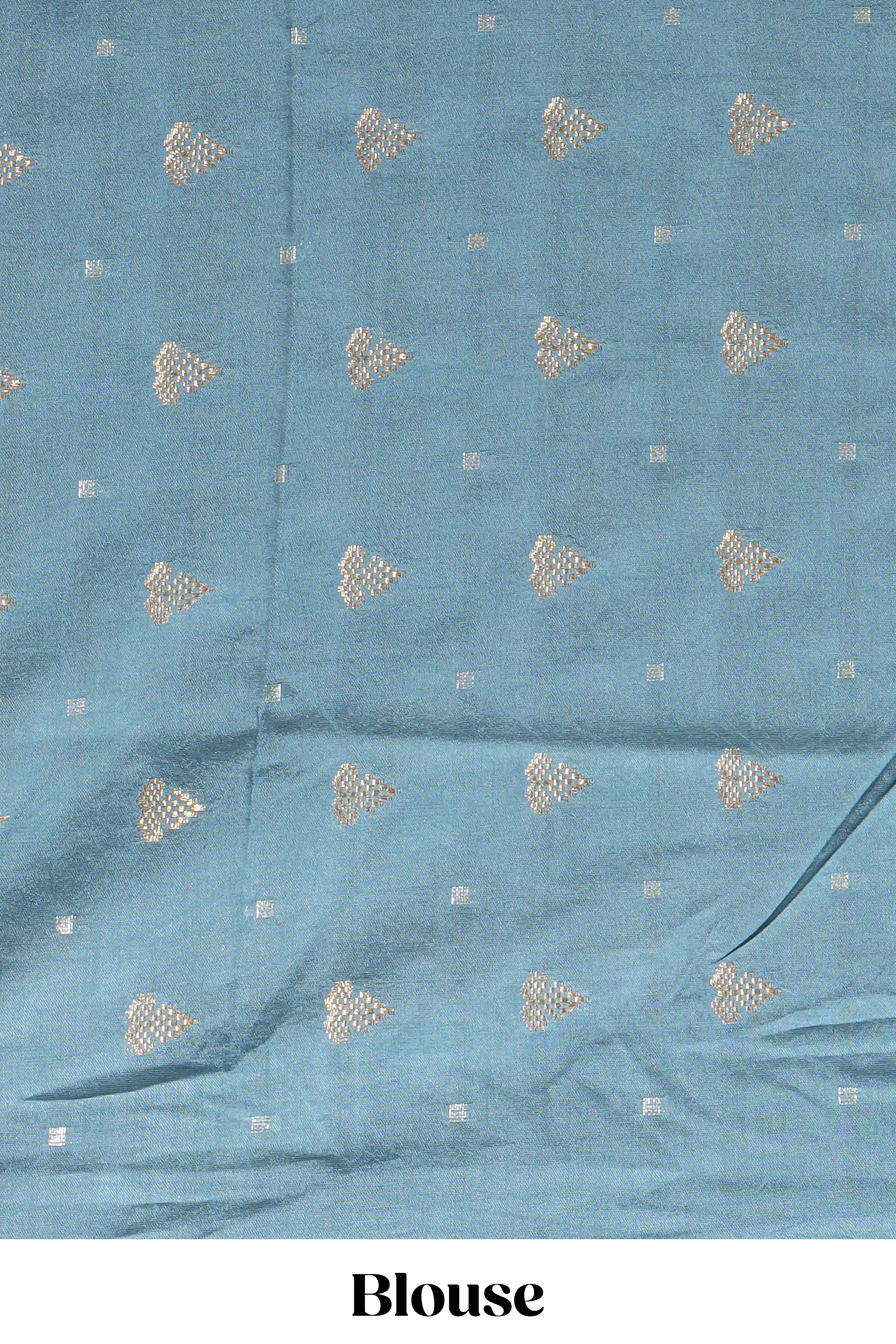Soft pink linen saree with floral print highlighted with a contrast floral pallu and metallic zari border along with contrast blouse piece