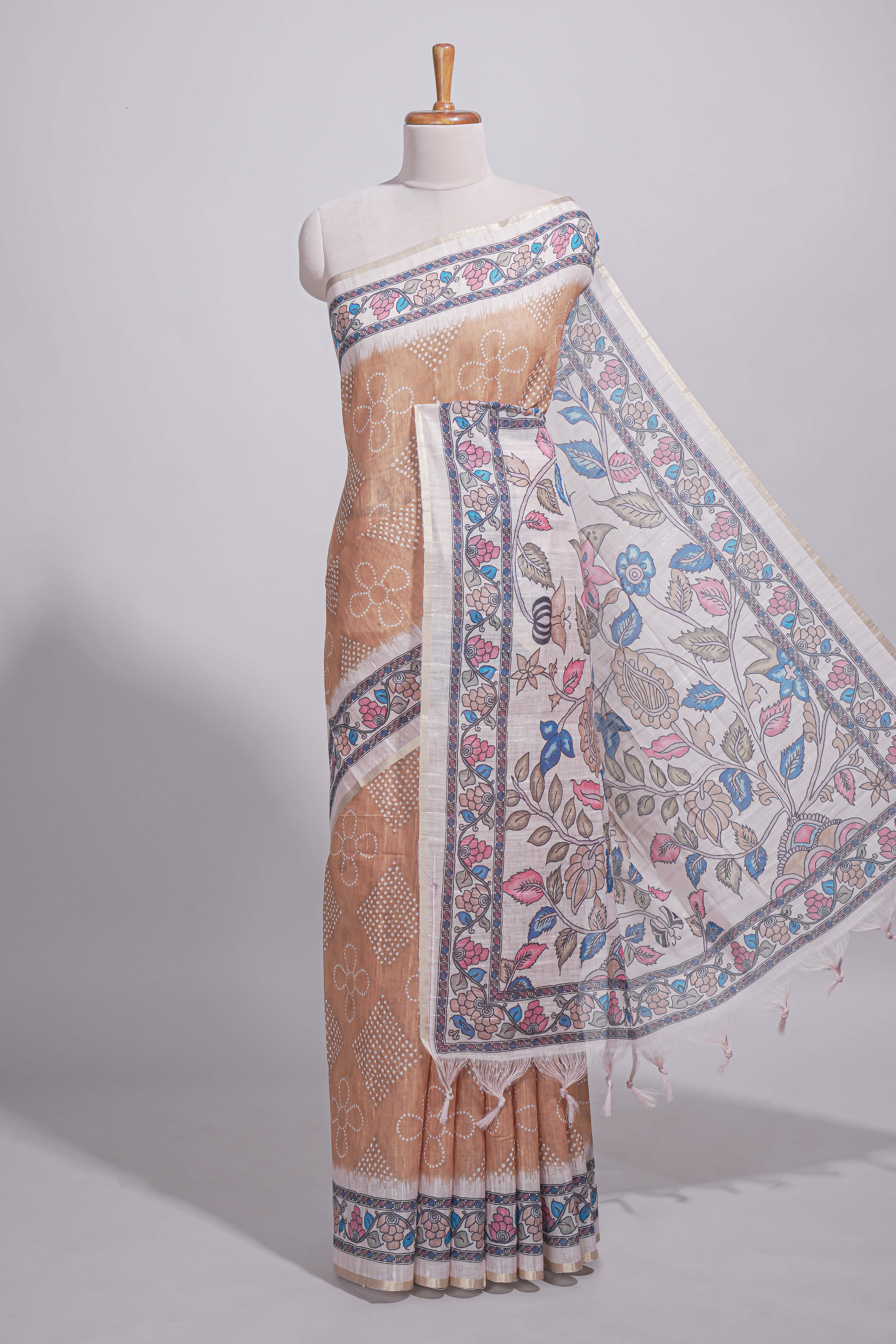 Beige color linen saree with floral and geometric prints multicolour floral border andprinted pallu with tassels with a contrast blouse piece