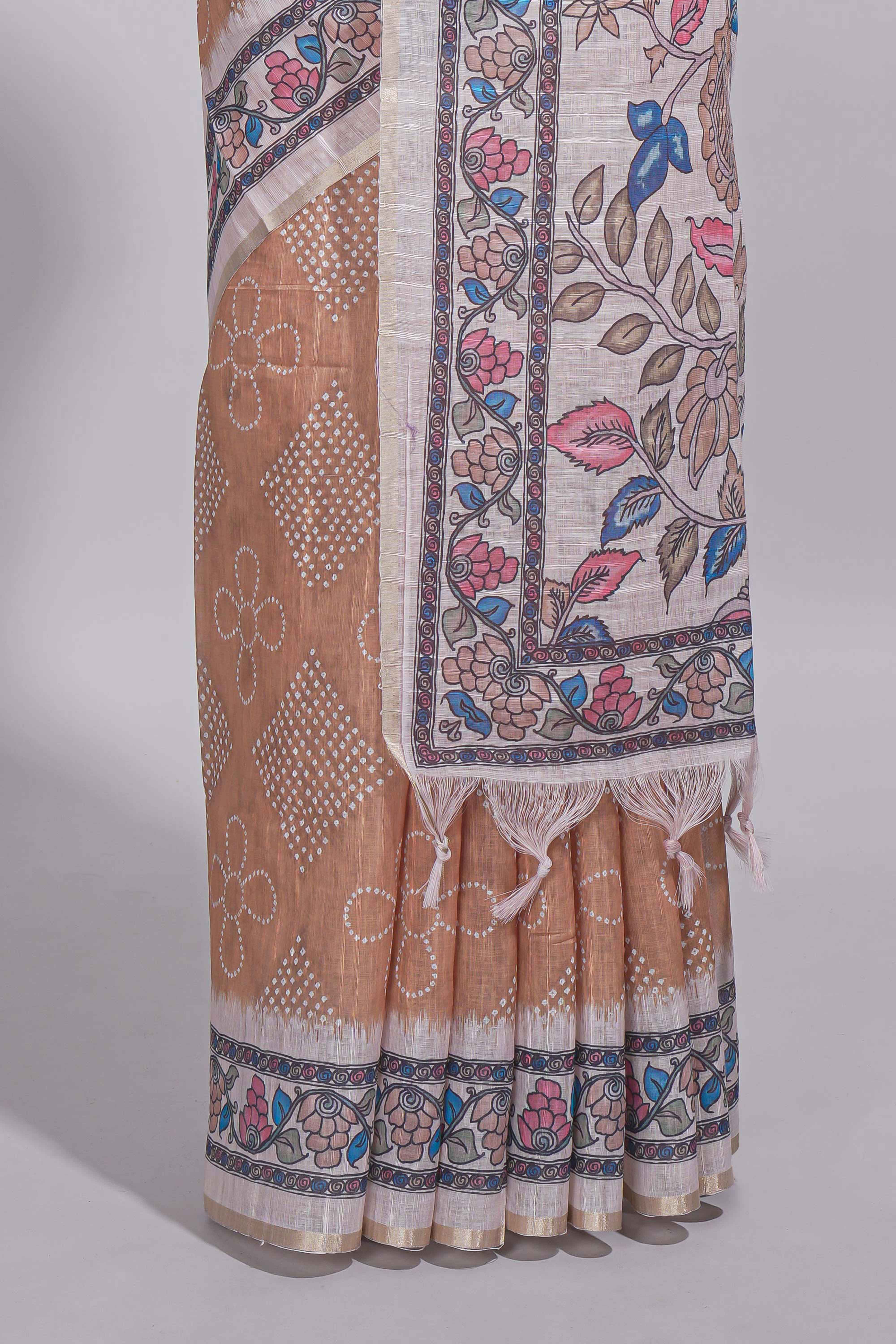 Beige color linen saree with floral and geometric prints multicolour floral border andprinted pallu with tassels with a contrast blouse piece