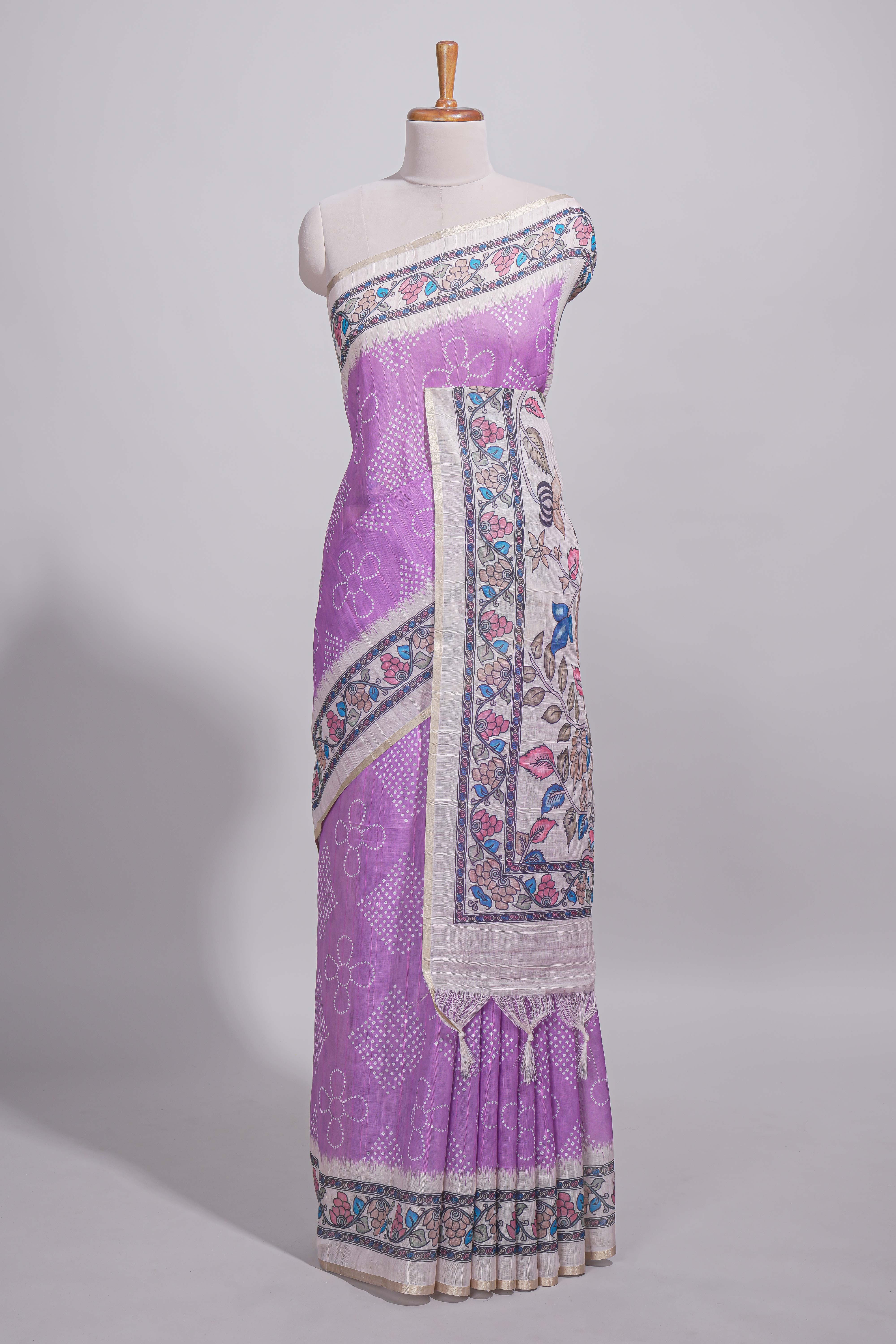 Lavender color linen saree with floral and geometric prints multicolour floral border andprinted pallu with tassels with a contrast blouse piece