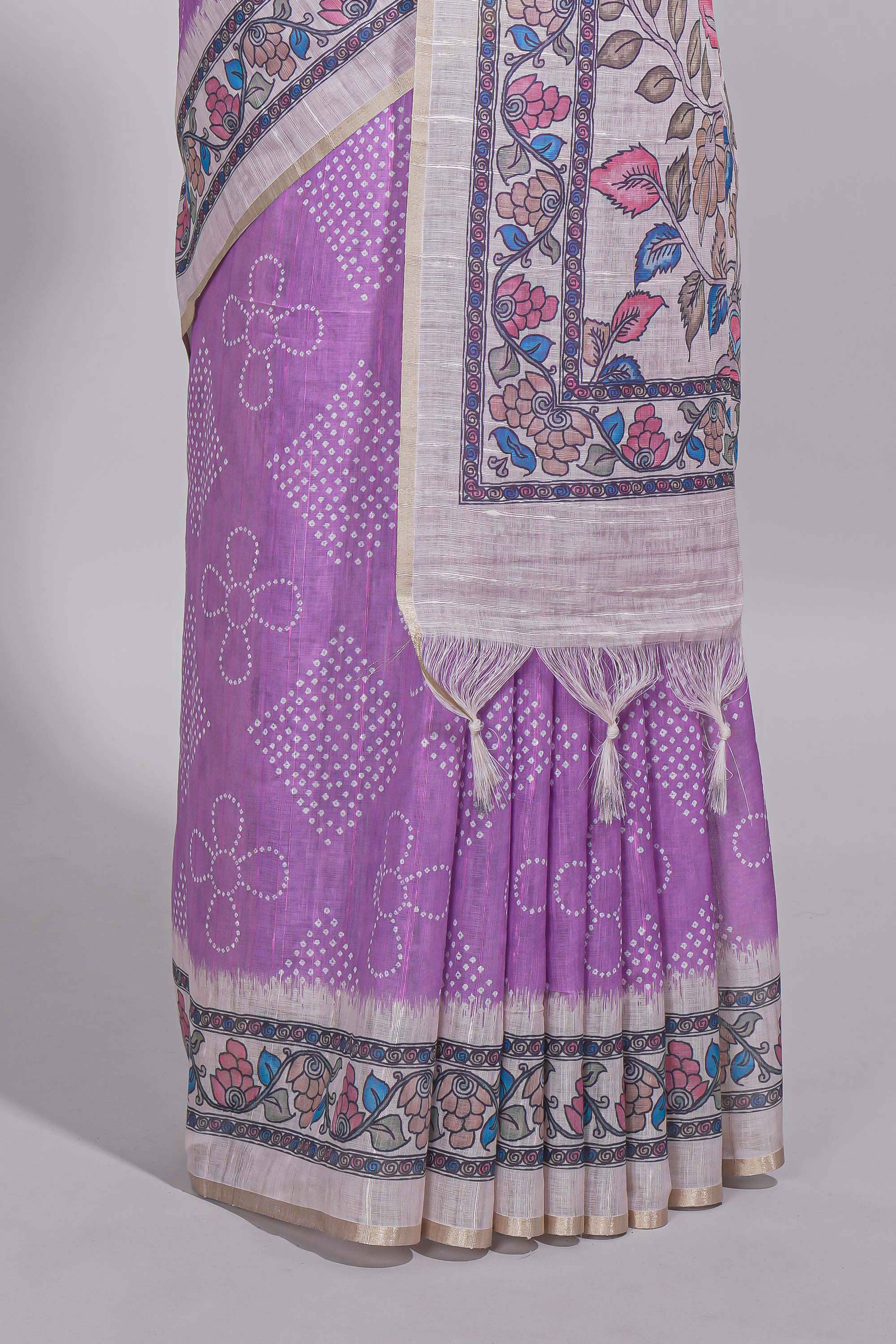 Lavender color linen saree with floral and geometric prints multicolour floral border andprinted pallu with tassels with a contrast blouse piece