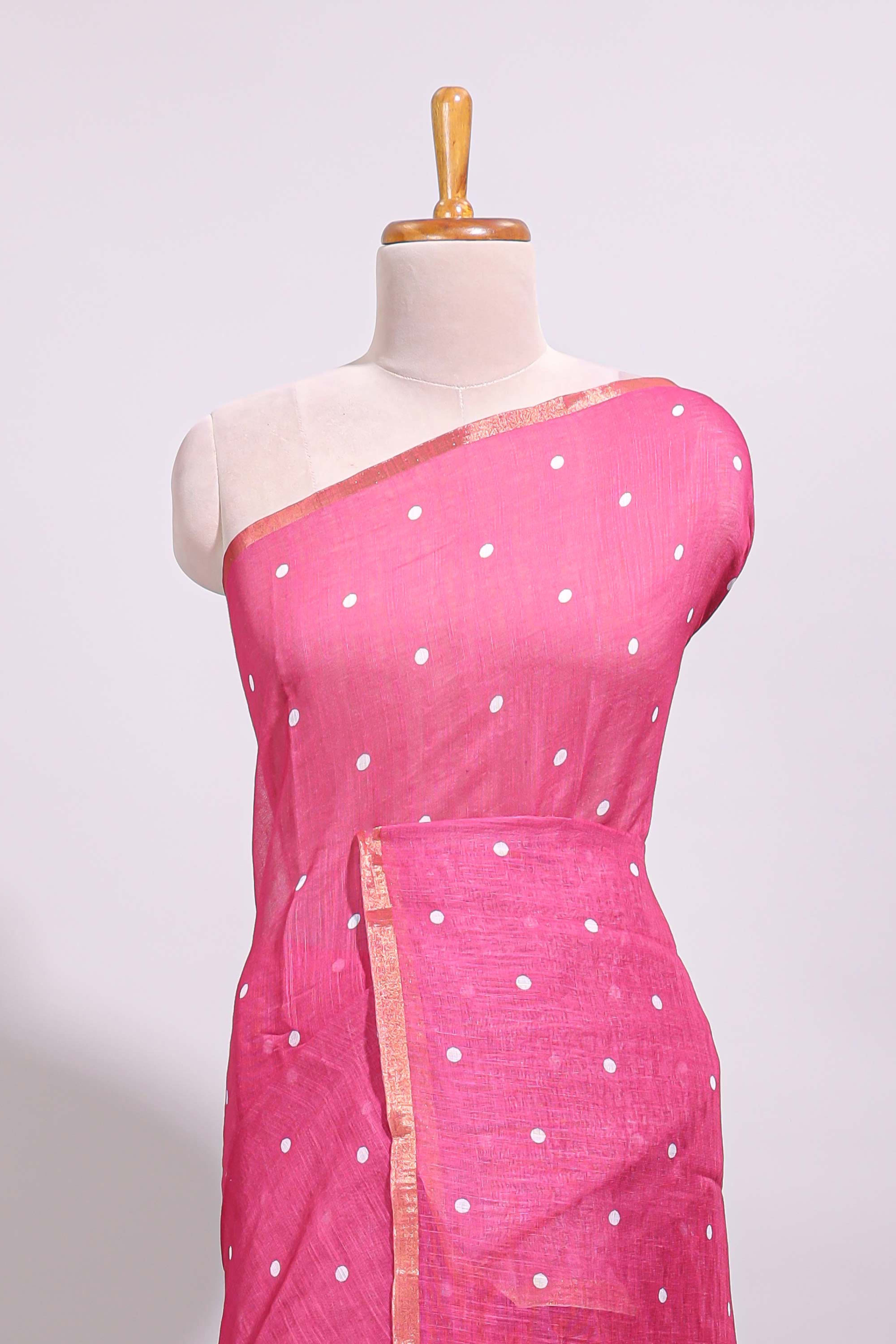 Pink round motifs linen saree with self zari border and contrast checked blouse