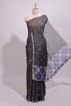 Black round motifs linen saree with self zari border and contrast checked blouse
