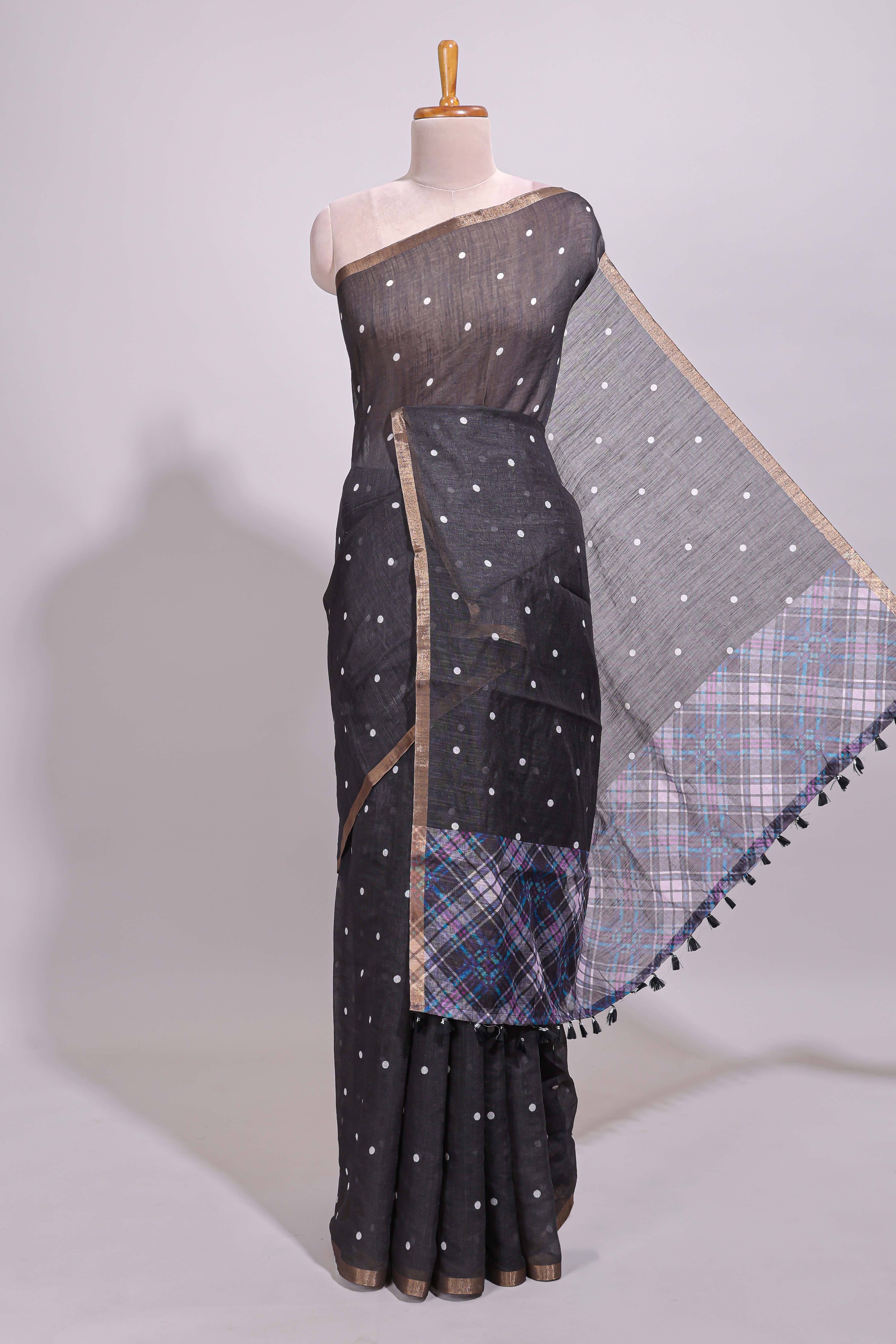 Black round motifs linen saree with self zari border and contrast checked blouse