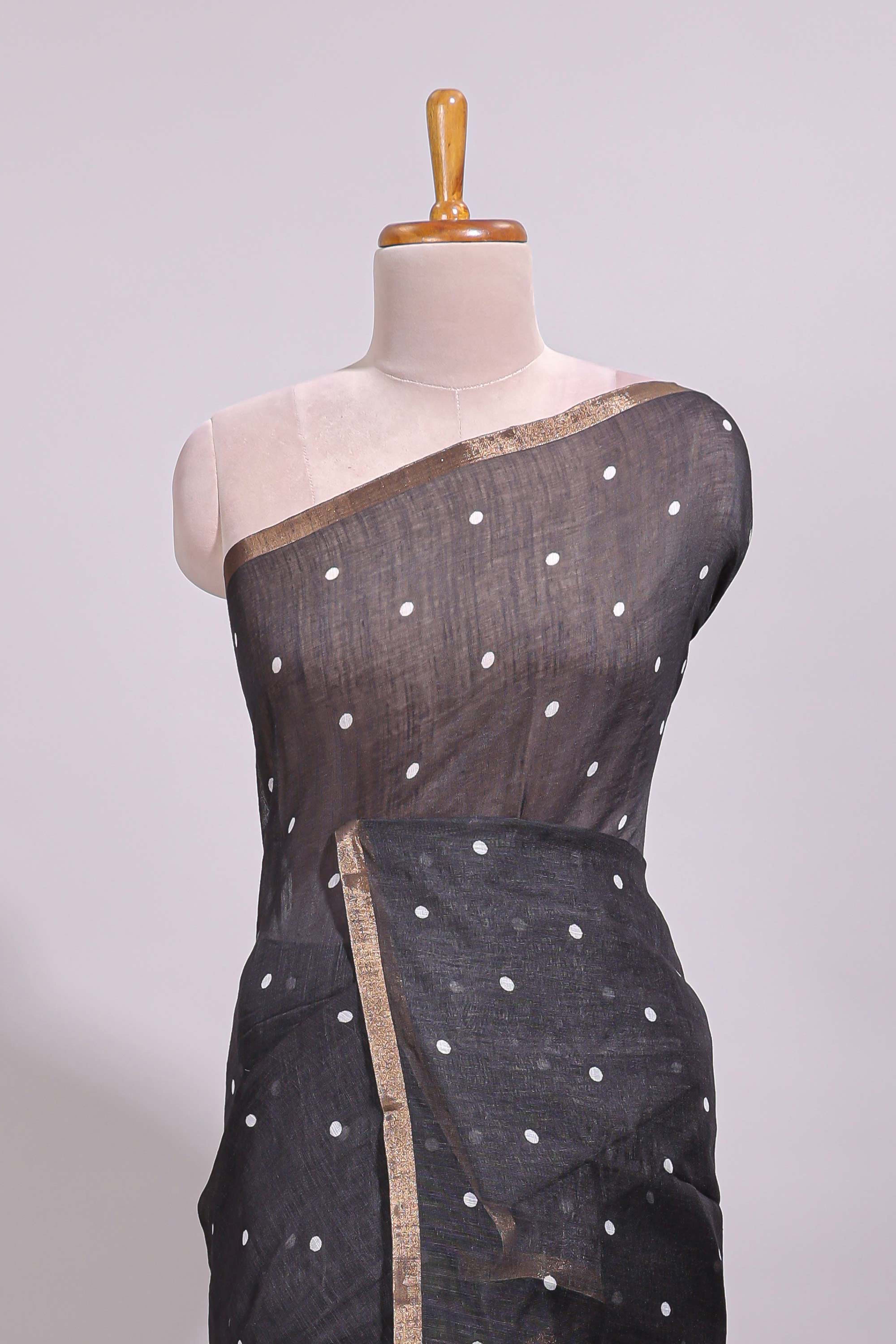 Black round motifs linen saree with self zari border and contrast checked blouse