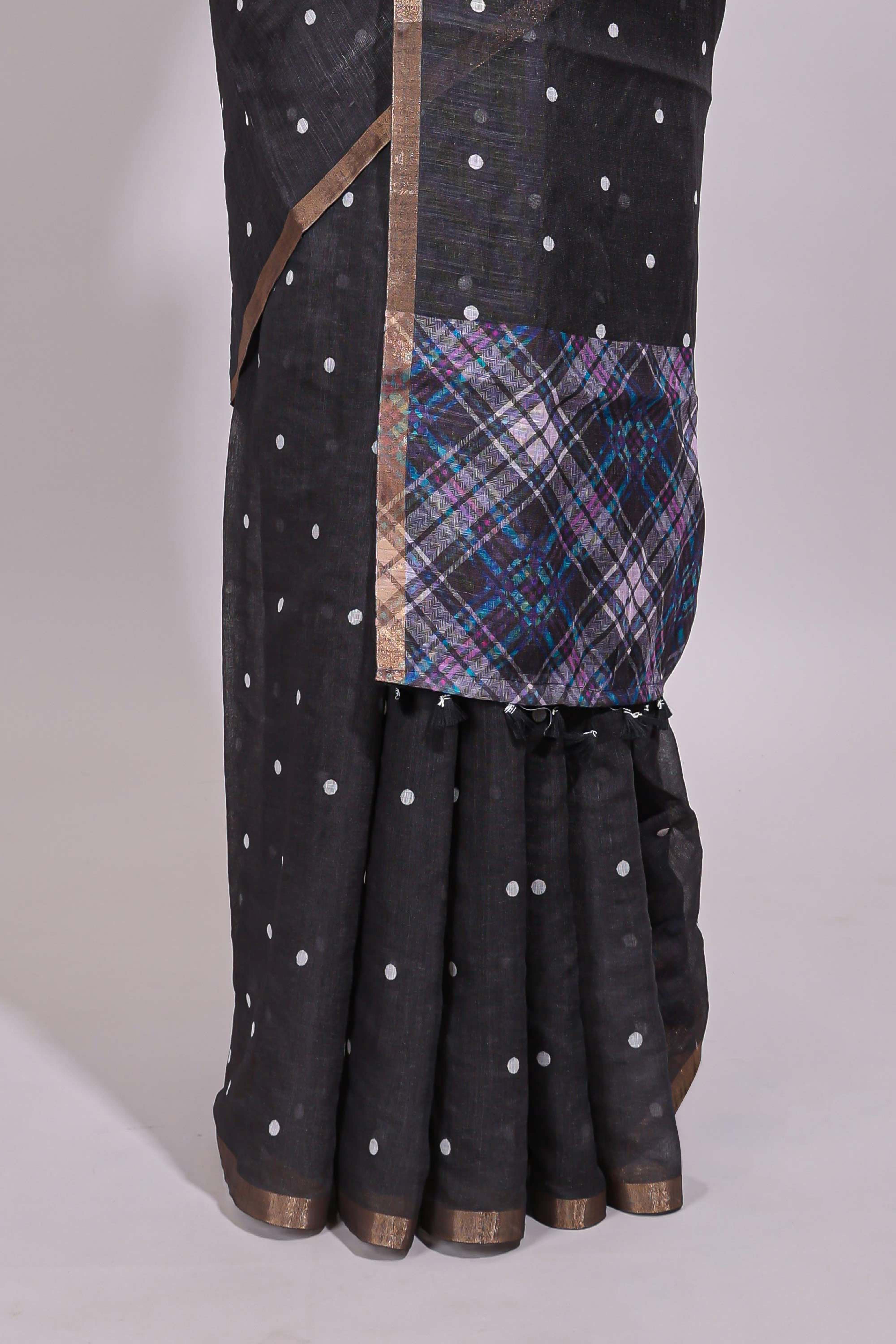 Black round motifs linen saree with self zari border and contrast checked blouse