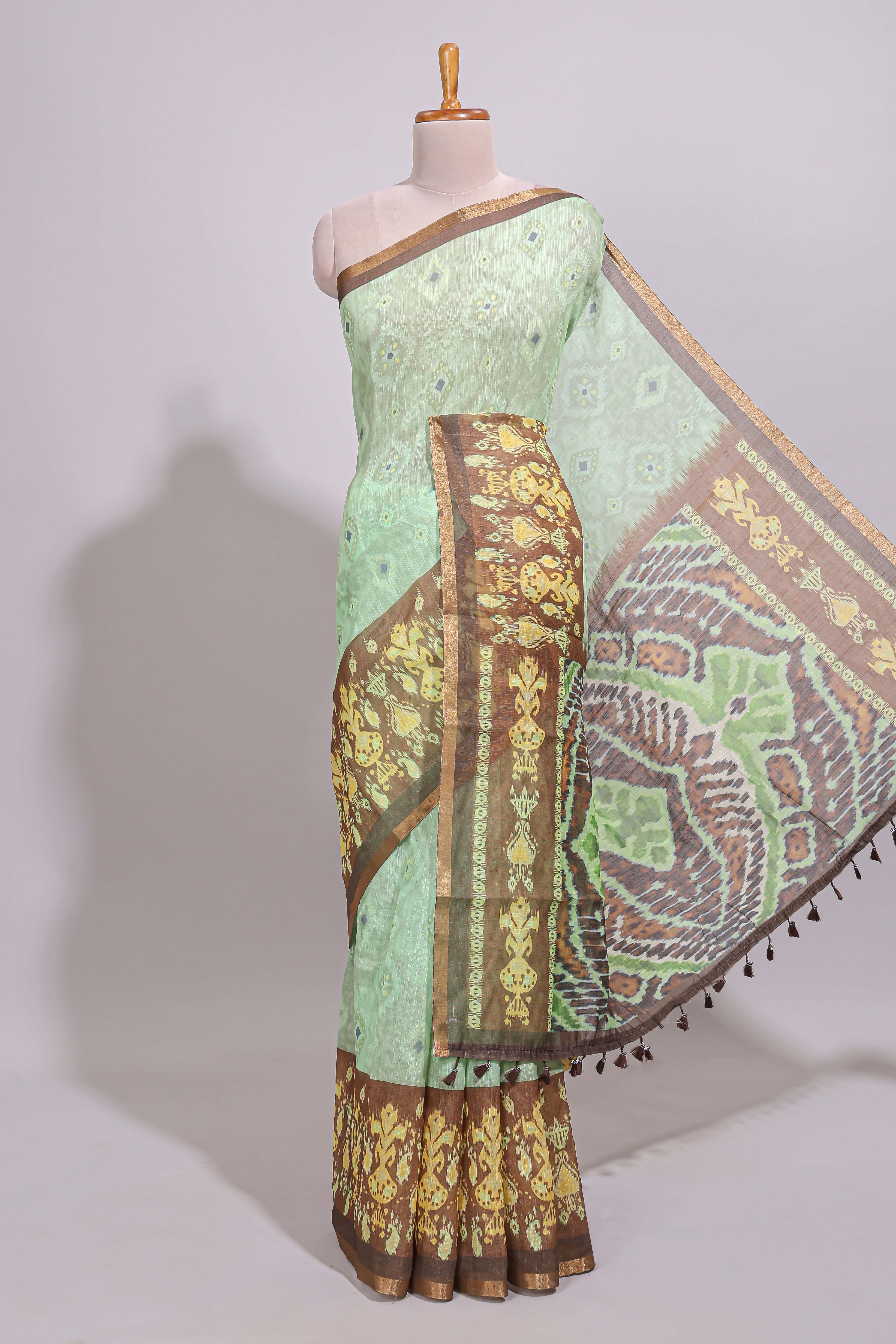 Green geometric ikkat design linen cotton saree with contrast zari border and printed blouse