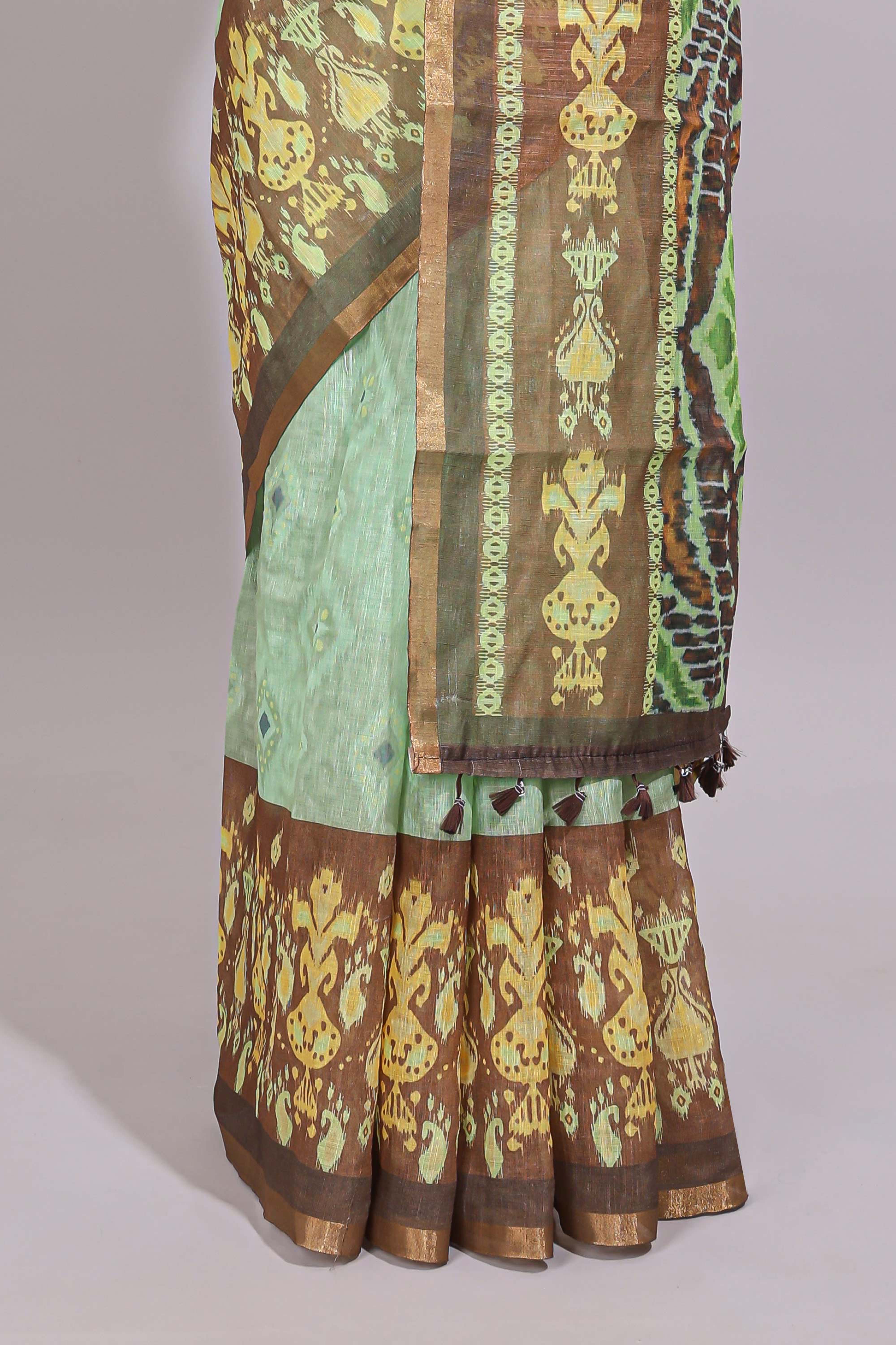 Green geometric ikkat design linen cotton saree with contrast zari border and printed blouse