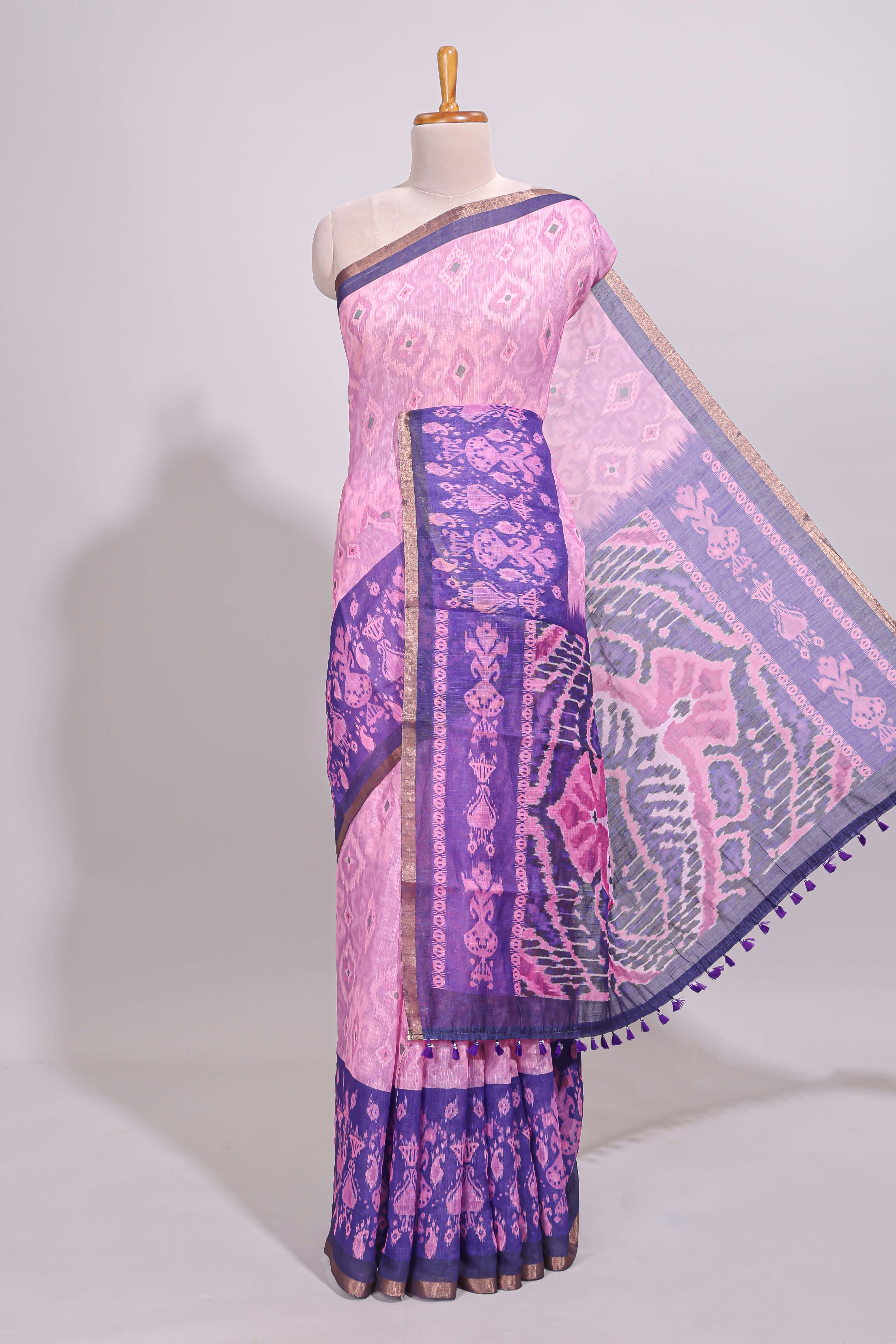 Pink geometric ikkat design linen cotton saree with contrast zari border and printed blouse