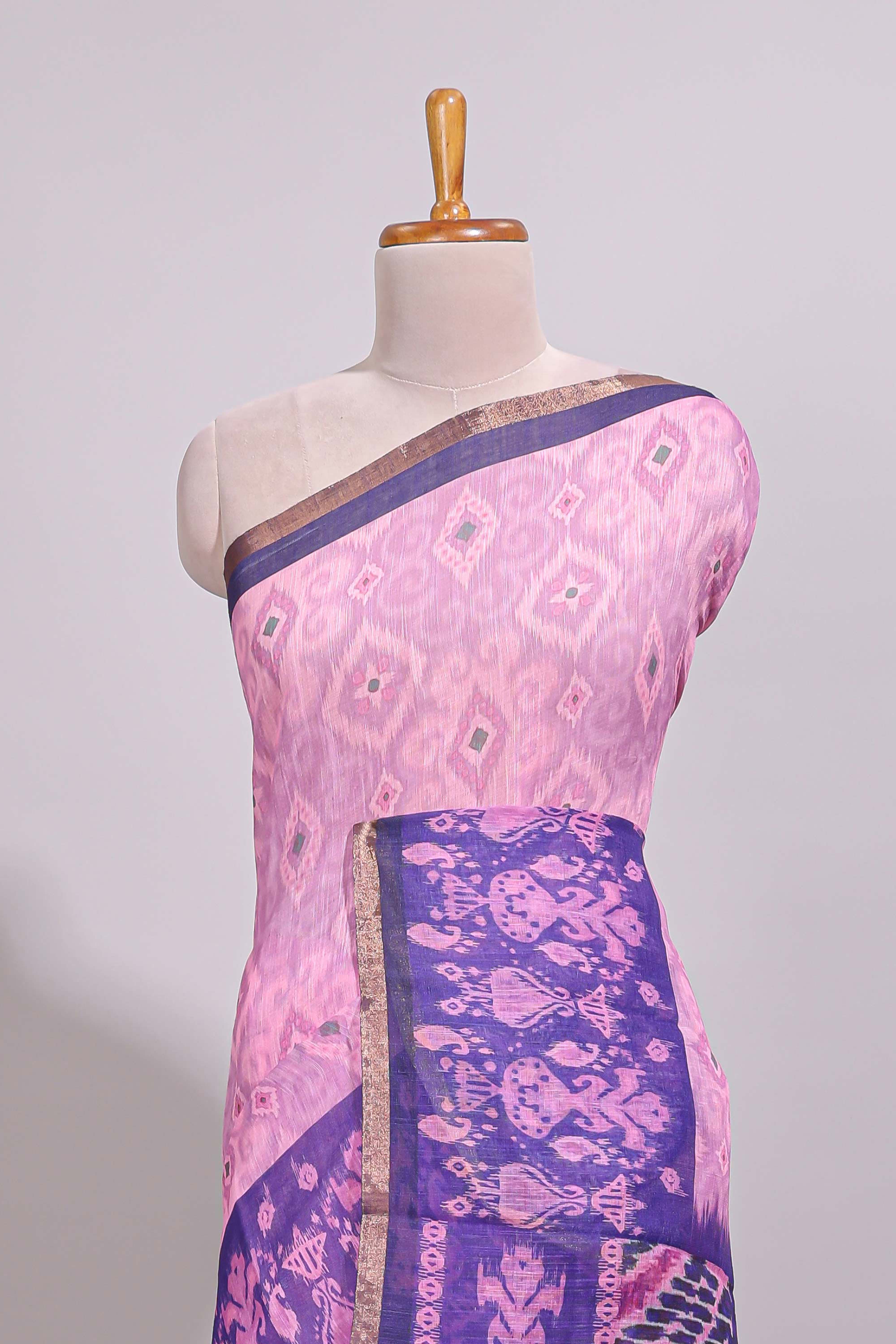 Pink geometric ikkat design linen cotton saree with contrast zari border and printed blouse