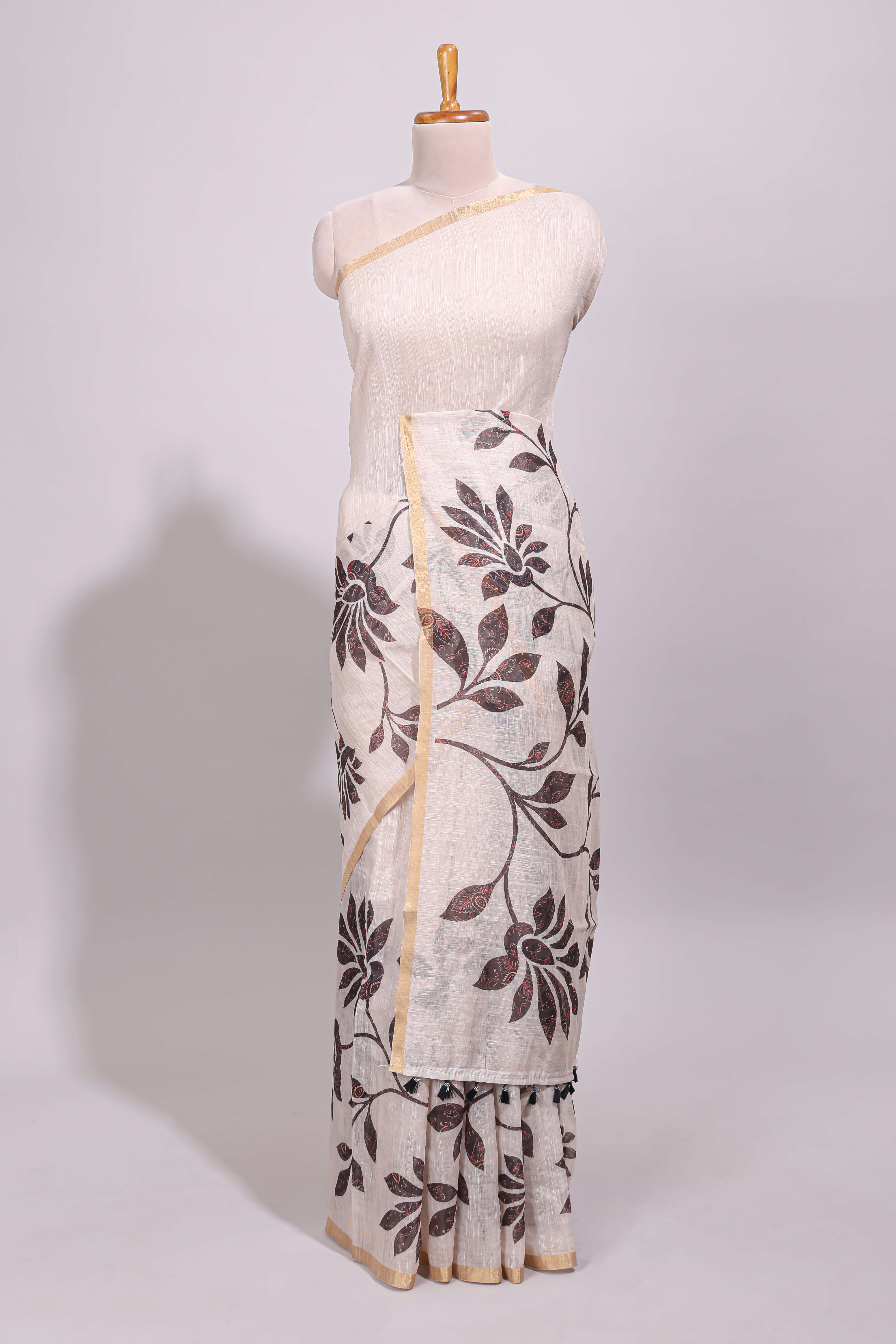 Cream floral design linen cotton saree with self zari border and contrast printed blouse